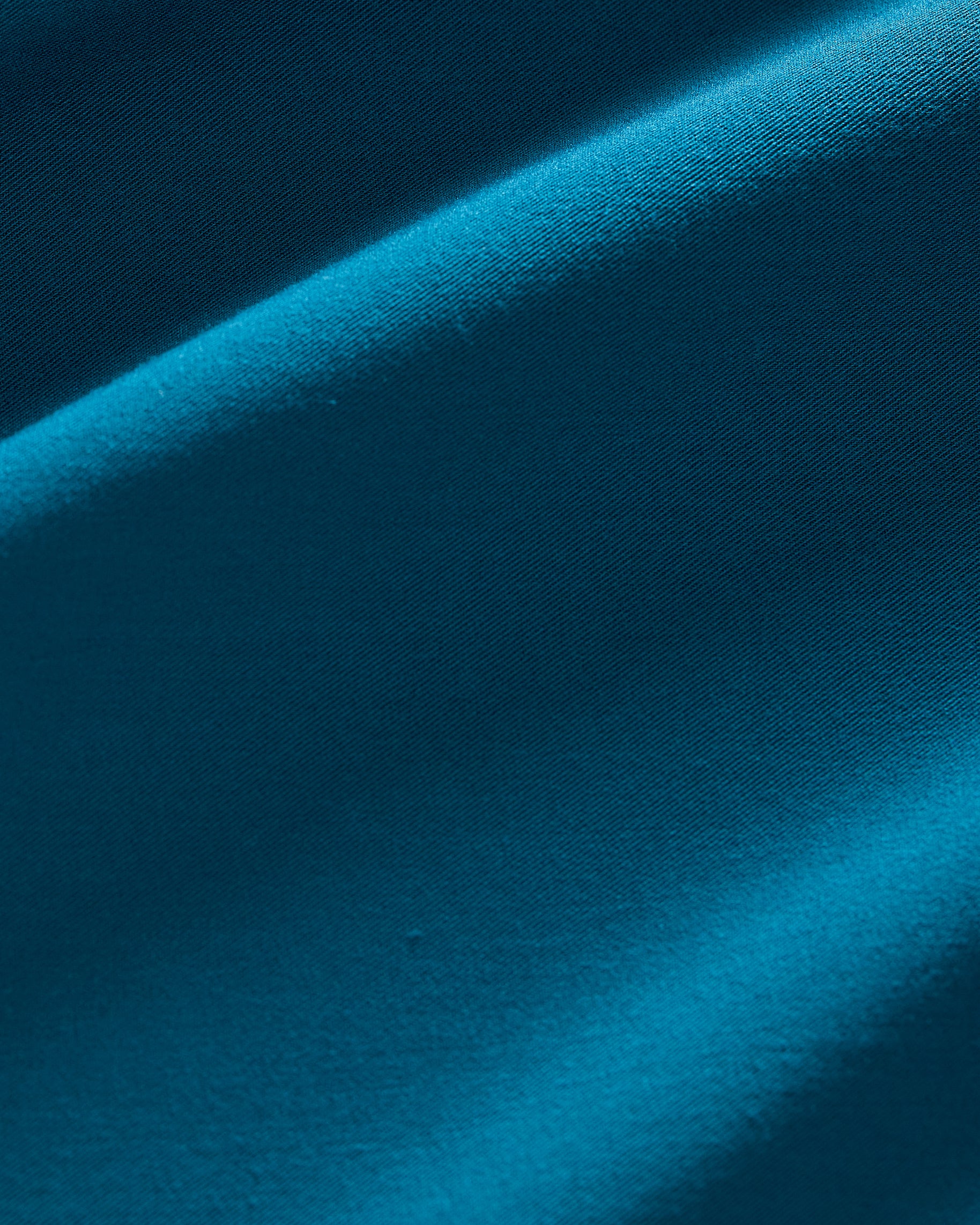 Close-up of smooth teal scrub fabric