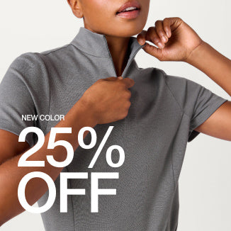 A woman wearing Graphite scrubs. There is text on the image, "New Color: 25% Off" - Women Nav Tile