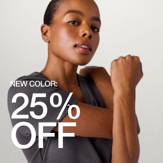 Image of woman wearing Harbor Gray scrubs. Image has text, New Color: 25% Off" - Women Nav Tile