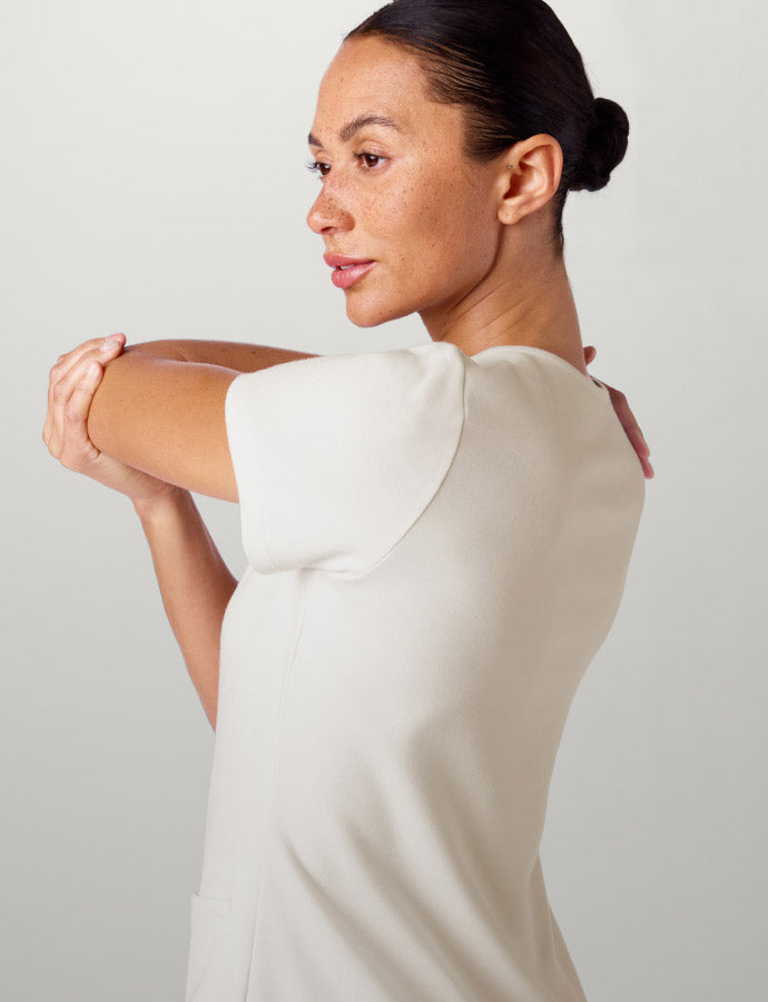 A woman wearing Frost colored scrub top.