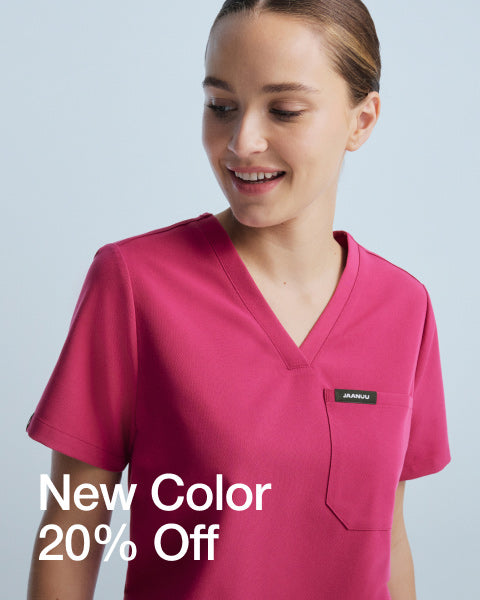 Woman wearing Wild Berry colored scrubs. Image has text, "New Color. 20% Off." - Women Nav Tile