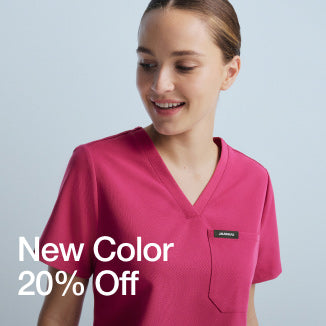 Woman wearing Wild Berry colored scrubs. Image has text, "New Color. 20% Off." - Women Nav Tile