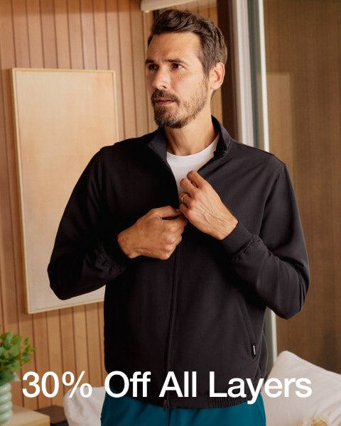A man wearing a JAANUU jacket, image has text, "30% Off All Layers". - Men Nav Tile