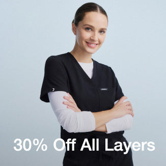 Image of a woman wearing a JAANUU underscrub with text saying, "30% Off All Layers" - Women Nav Tile