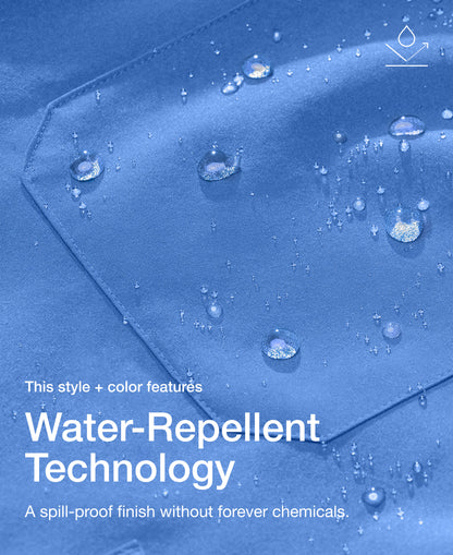 Close up view of Jaanuu fabric in Ceil Blue with water beading on a chest pocket. Text on the image reads "This style + color features Water-Repellent Technology. A spill-proof finish without forever chemicals."