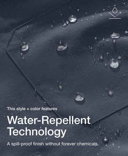 Close up view of Jaanuu fabric in Carbon Gray with water beading on a chest pocket. Text on the image reads "This style + color features Water-Repellent Technology. A spill-proof finish without forever chemicals."