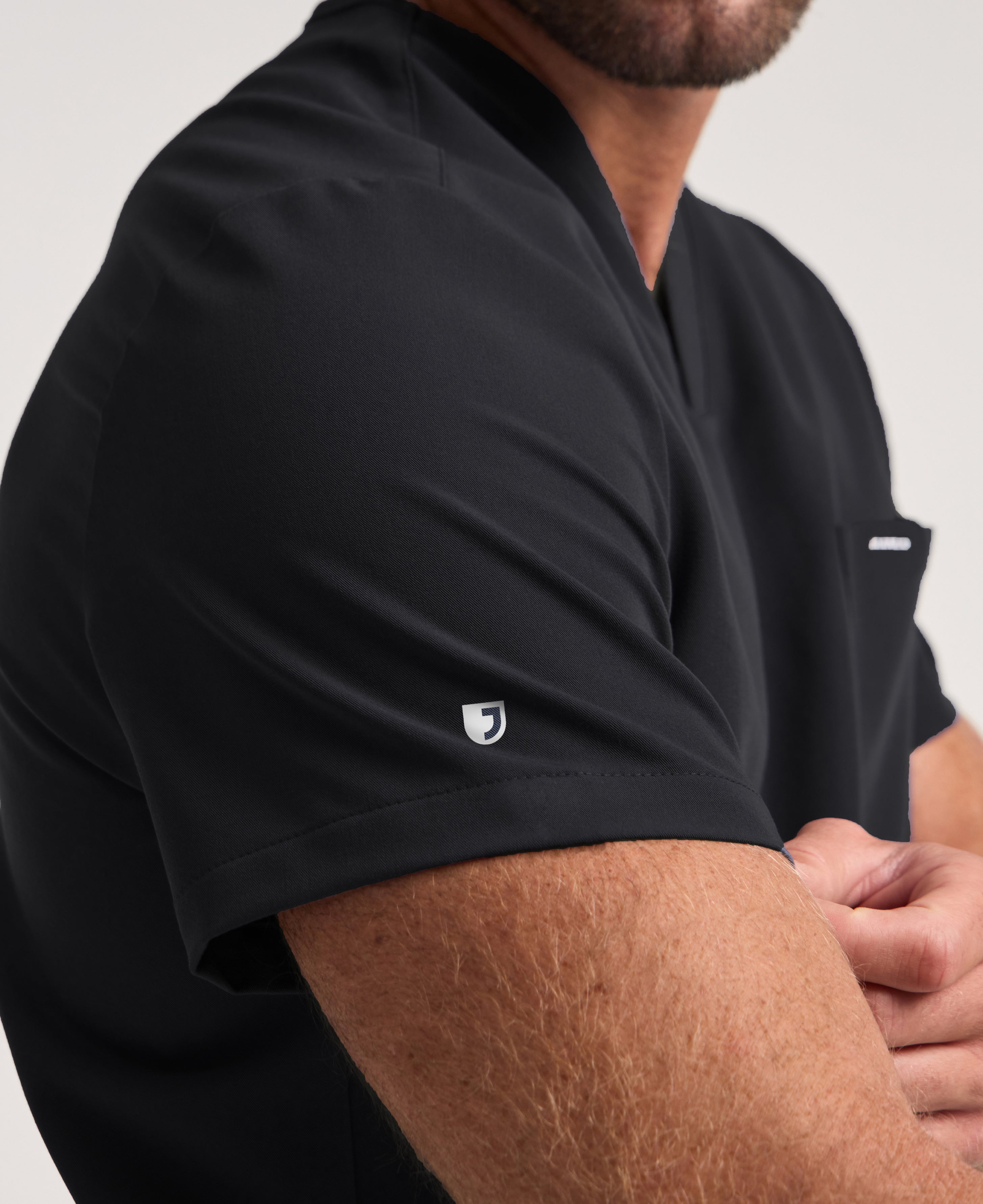 Jaanuu Holmes 1-Pocket Scrub Top in Black, product photo 5 of 6