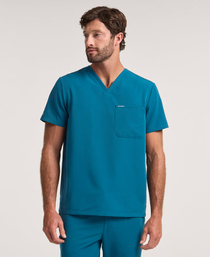 Jaanuu Holmes 1-Pocket Scrub Top in Caribbean Blue, product photo 1 of 6