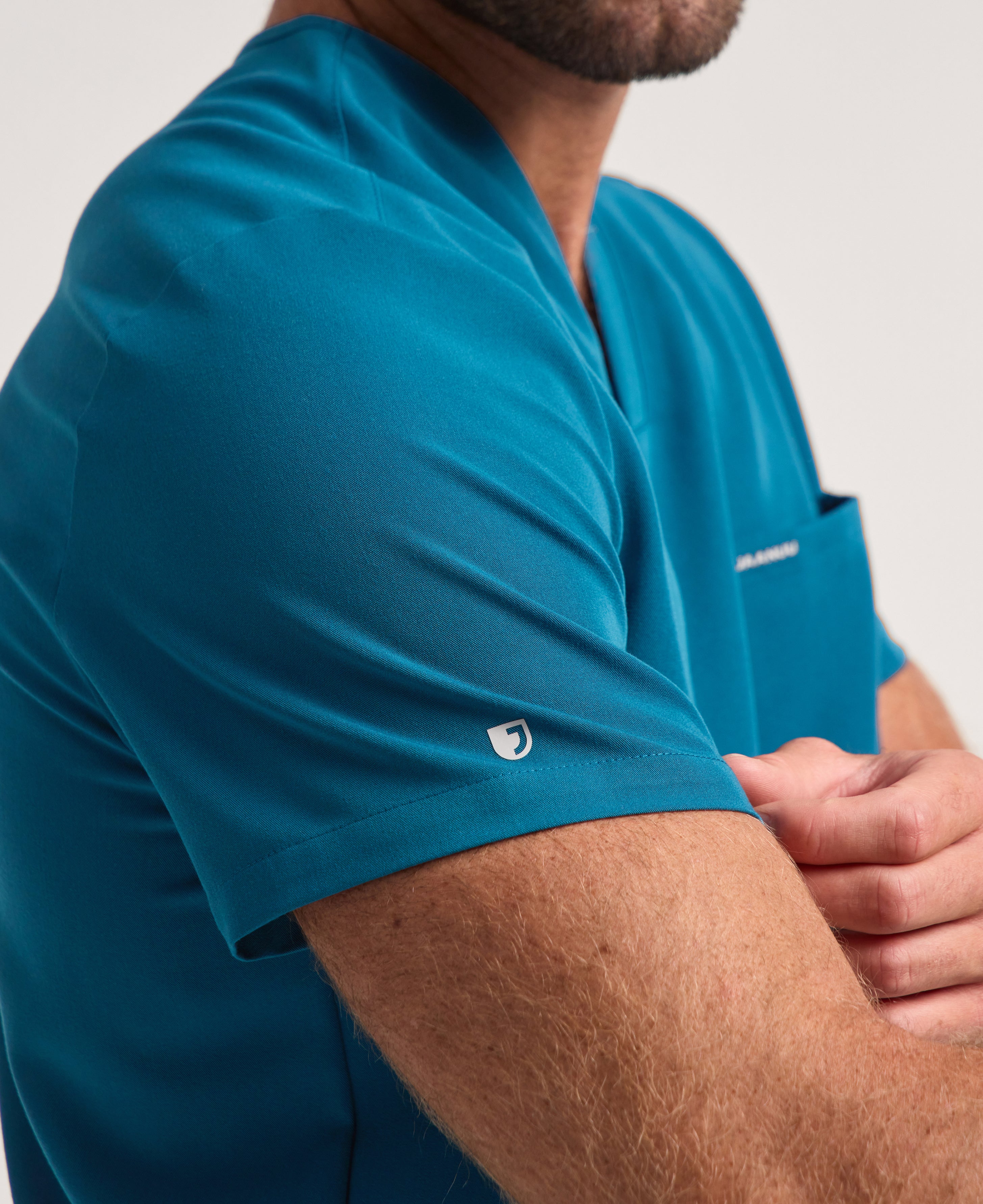 Jaanuu Holmes 1-Pocket Scrub Top in Caribbean Blue, product photo 4 of 6