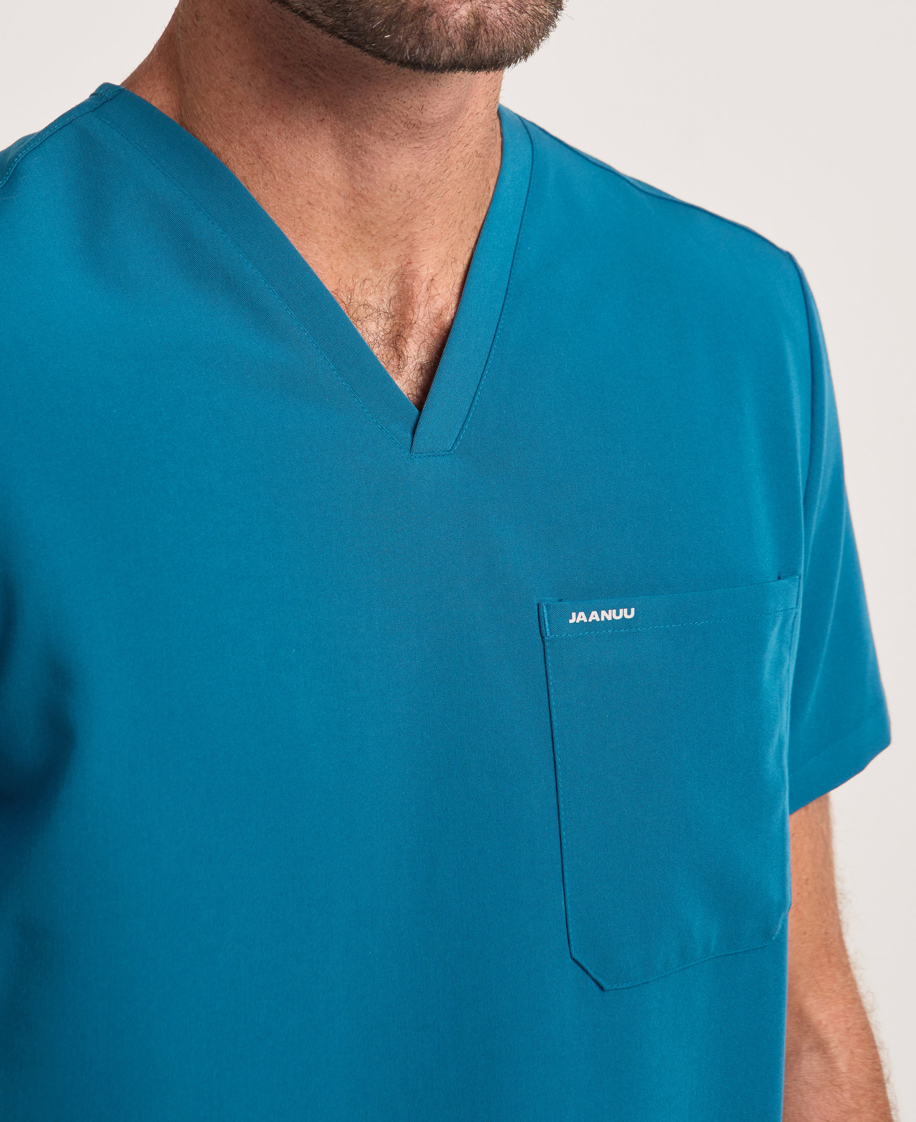 Jaanuu Holmes 1-Pocket Scrub Top in Caribbean Blue, product photo 5 of 6
