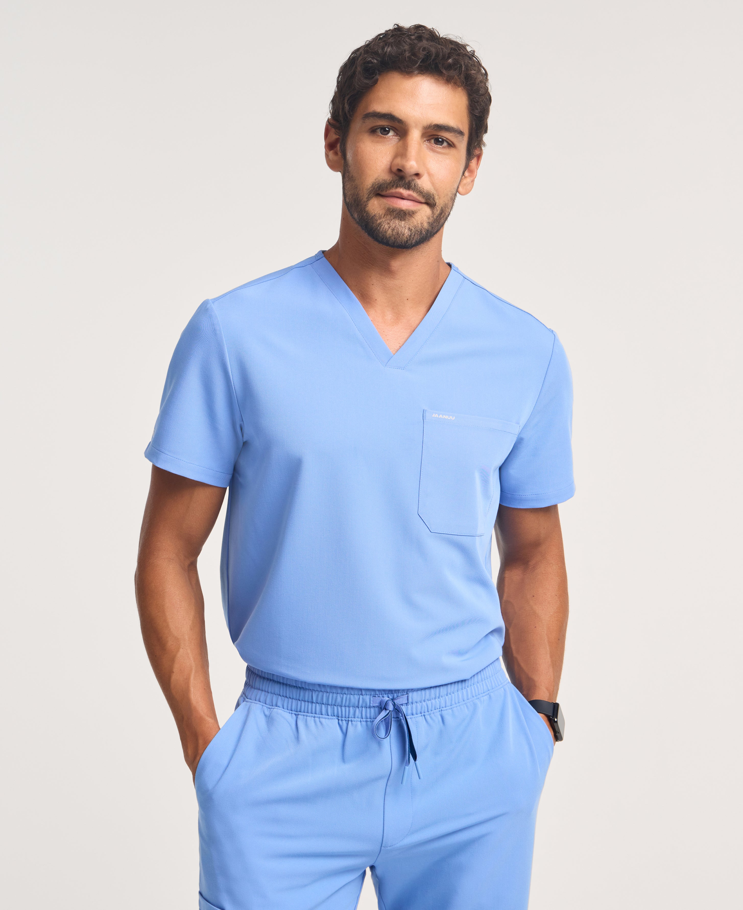 Jaanuu Holmes 1-Pocket Scrub Top in Ceil Blue, product photo 1 of 6