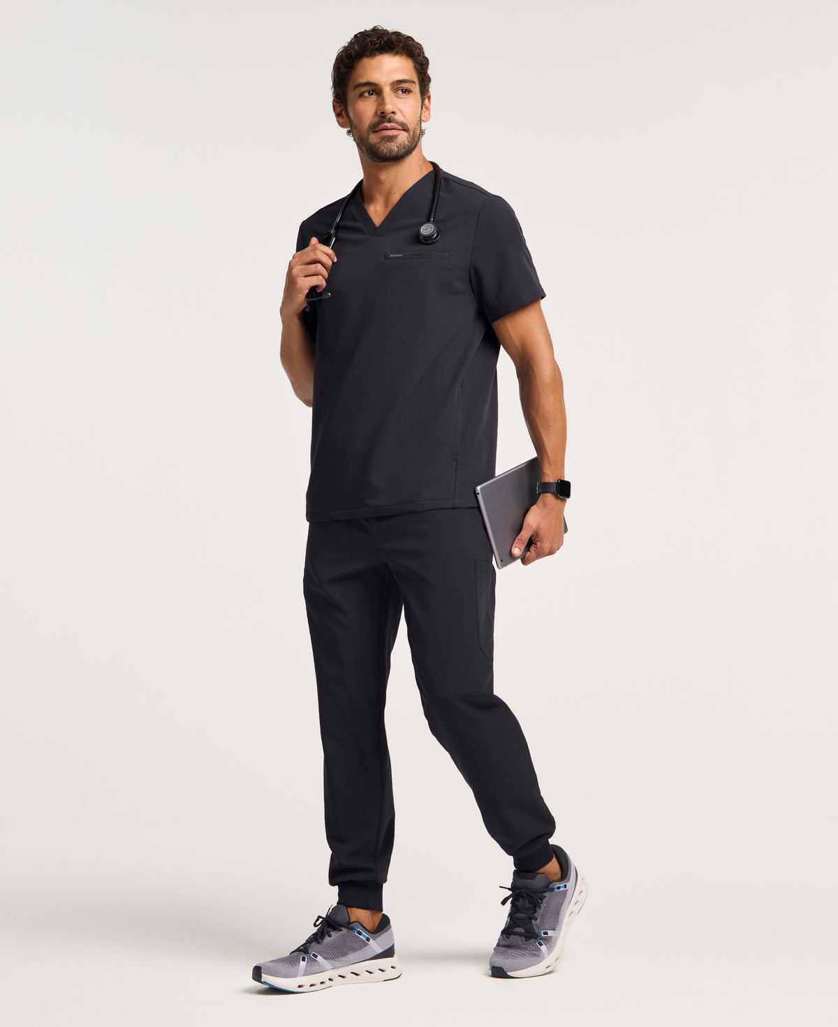 Jaanuu Platt 3-Pocket Scrub Top in Black, product photo 4 of 6