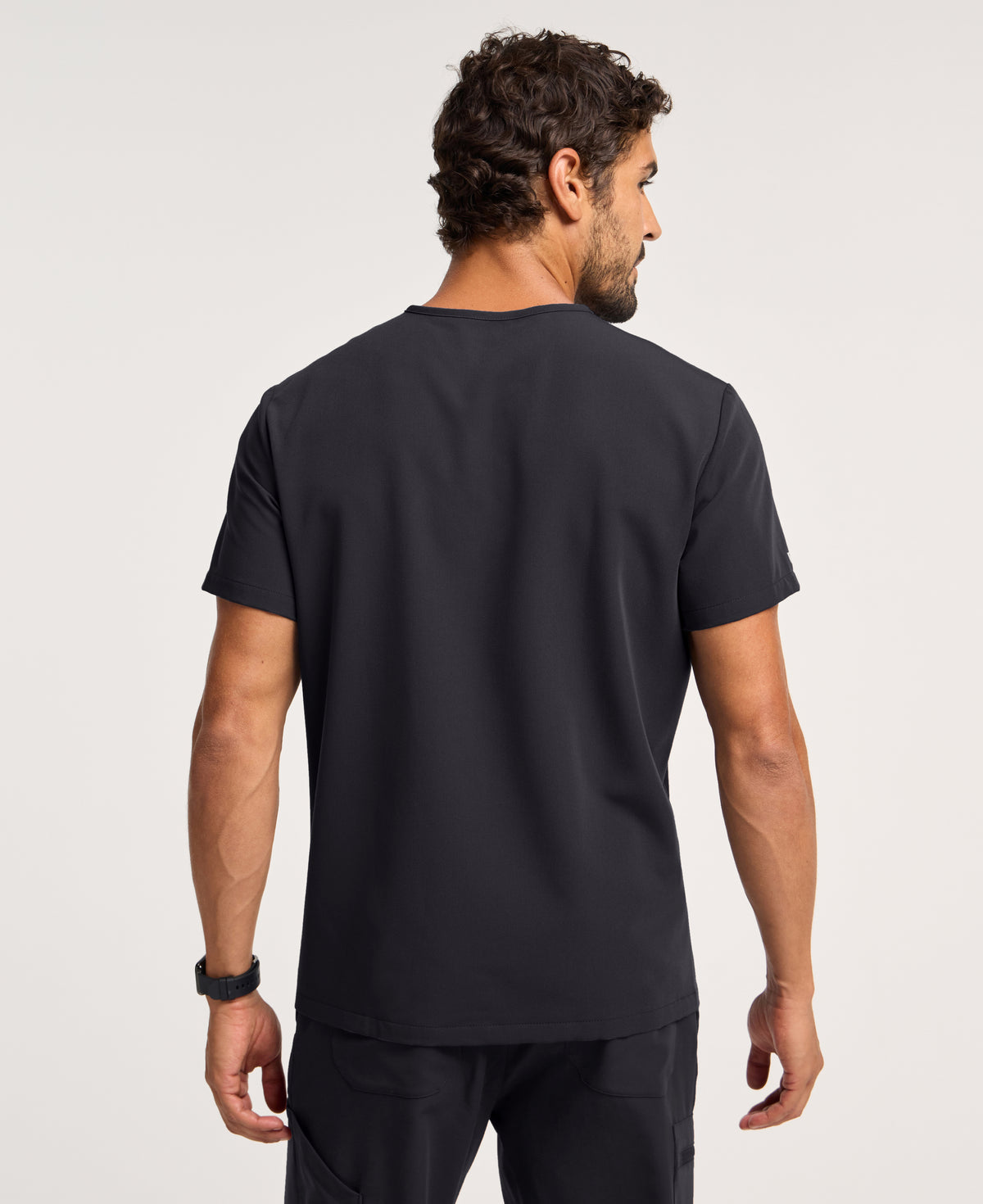 Jaanuu Platt 3-Pocket Scrub Top in Black, product photo 5 of 6