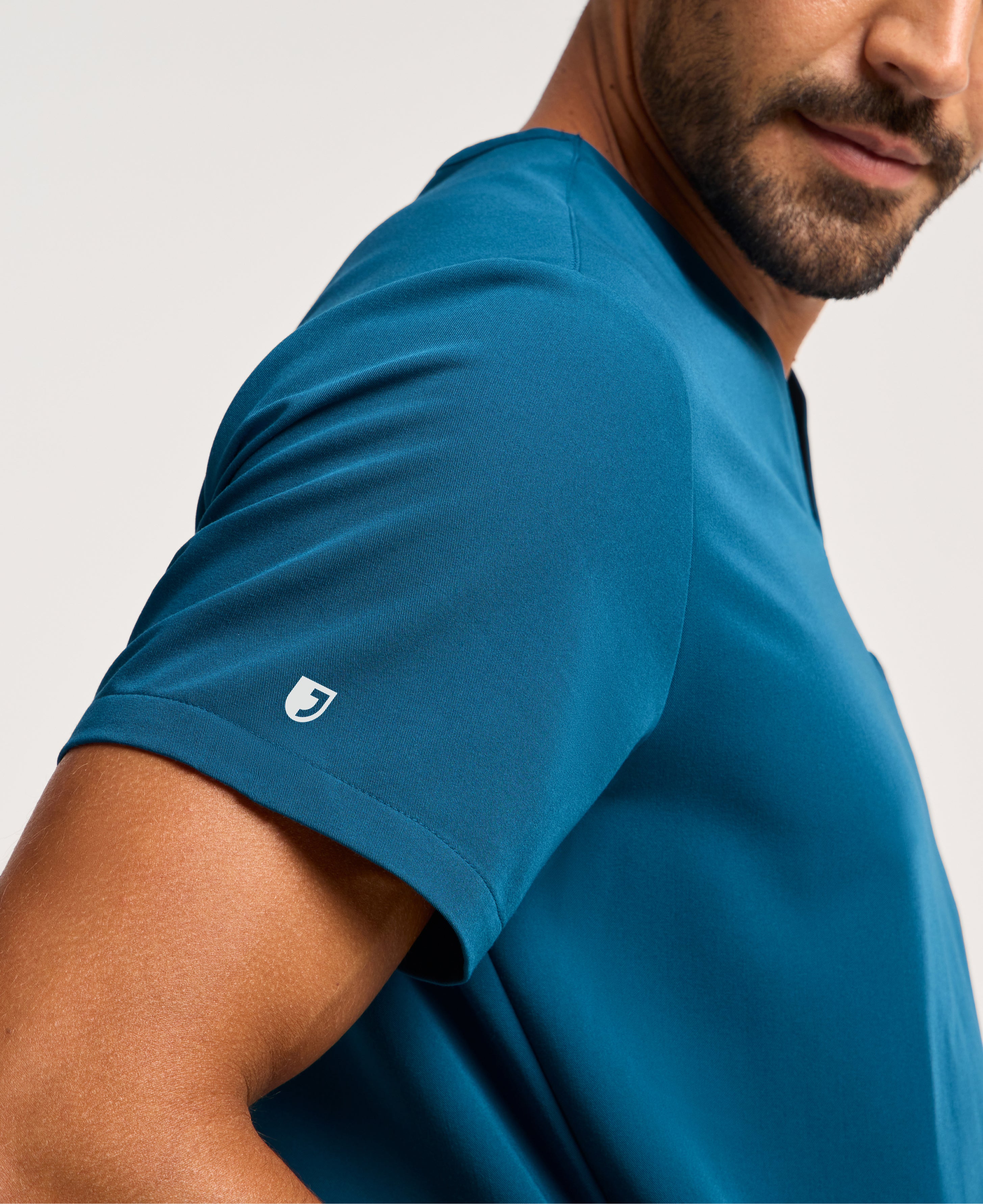 Jaanuu Platt 3-Pocket Scrub Top in Caribbean Blue, product photo 2 of 6
