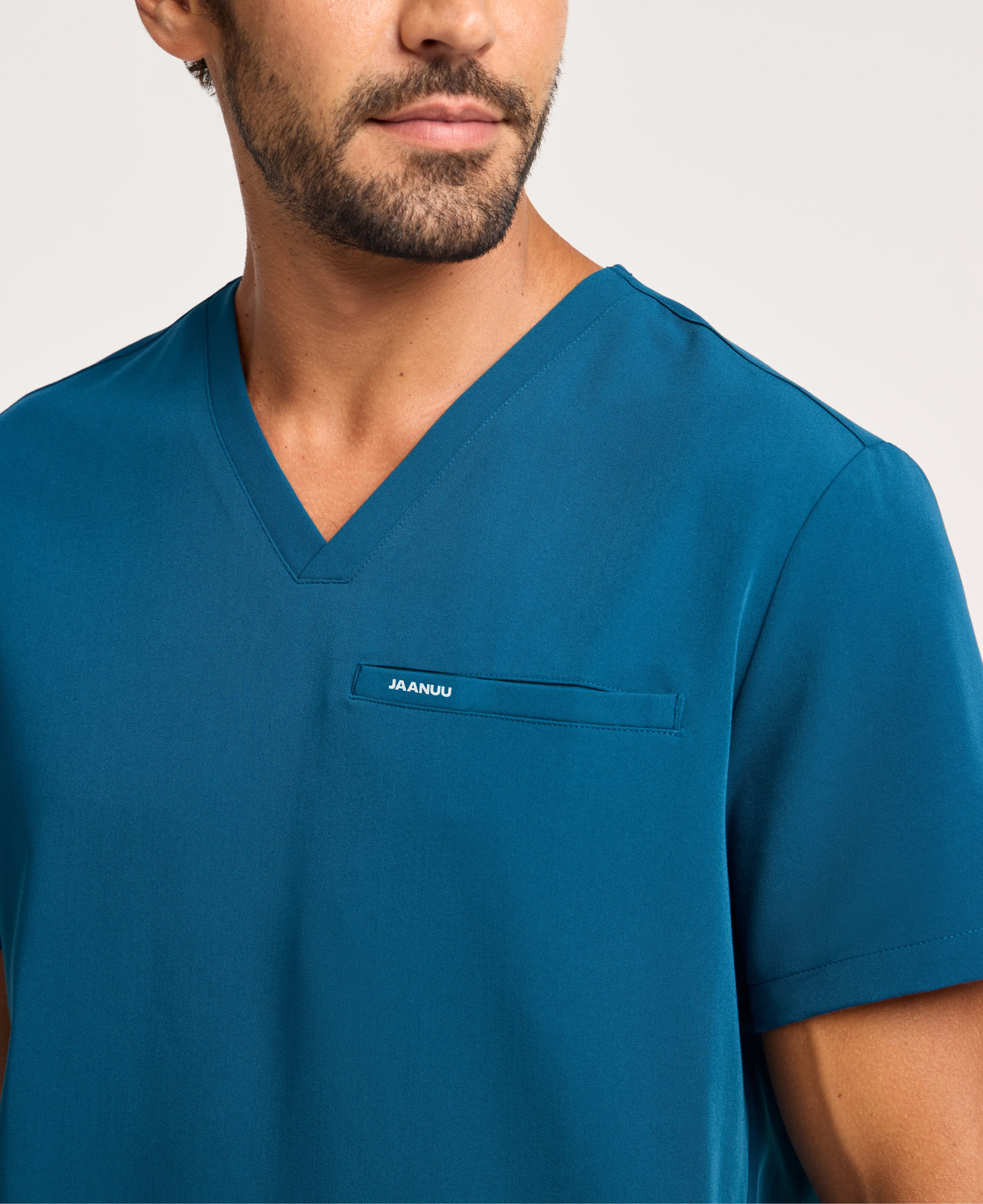 Jaanuu Platt 3-Pocket Scrub Top in Caribbean Blue, product photo 6 of 6