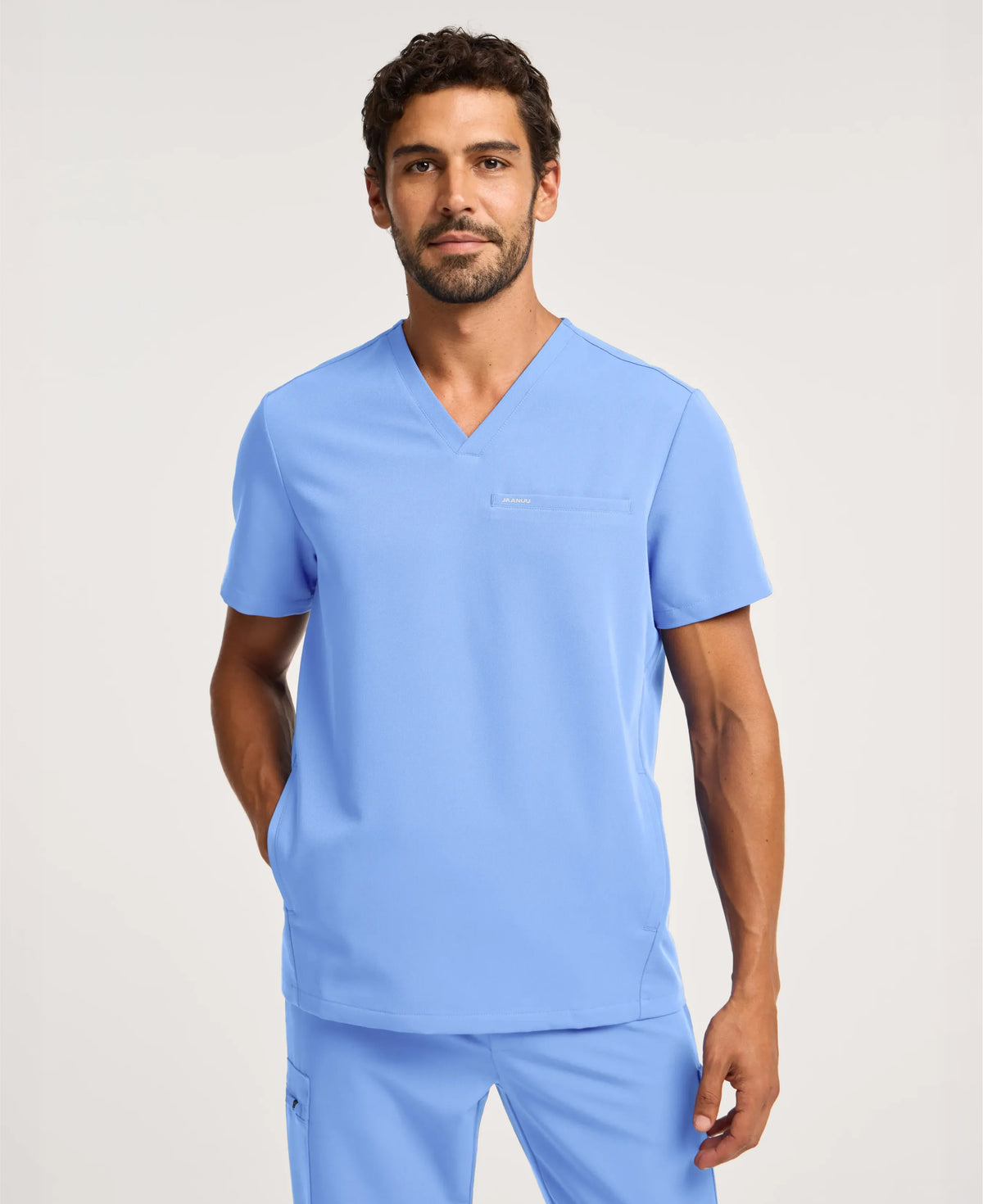 Jaanuu Platt 3-Pocket Scrub Top in Ceil Blue, product photo 1 of 6