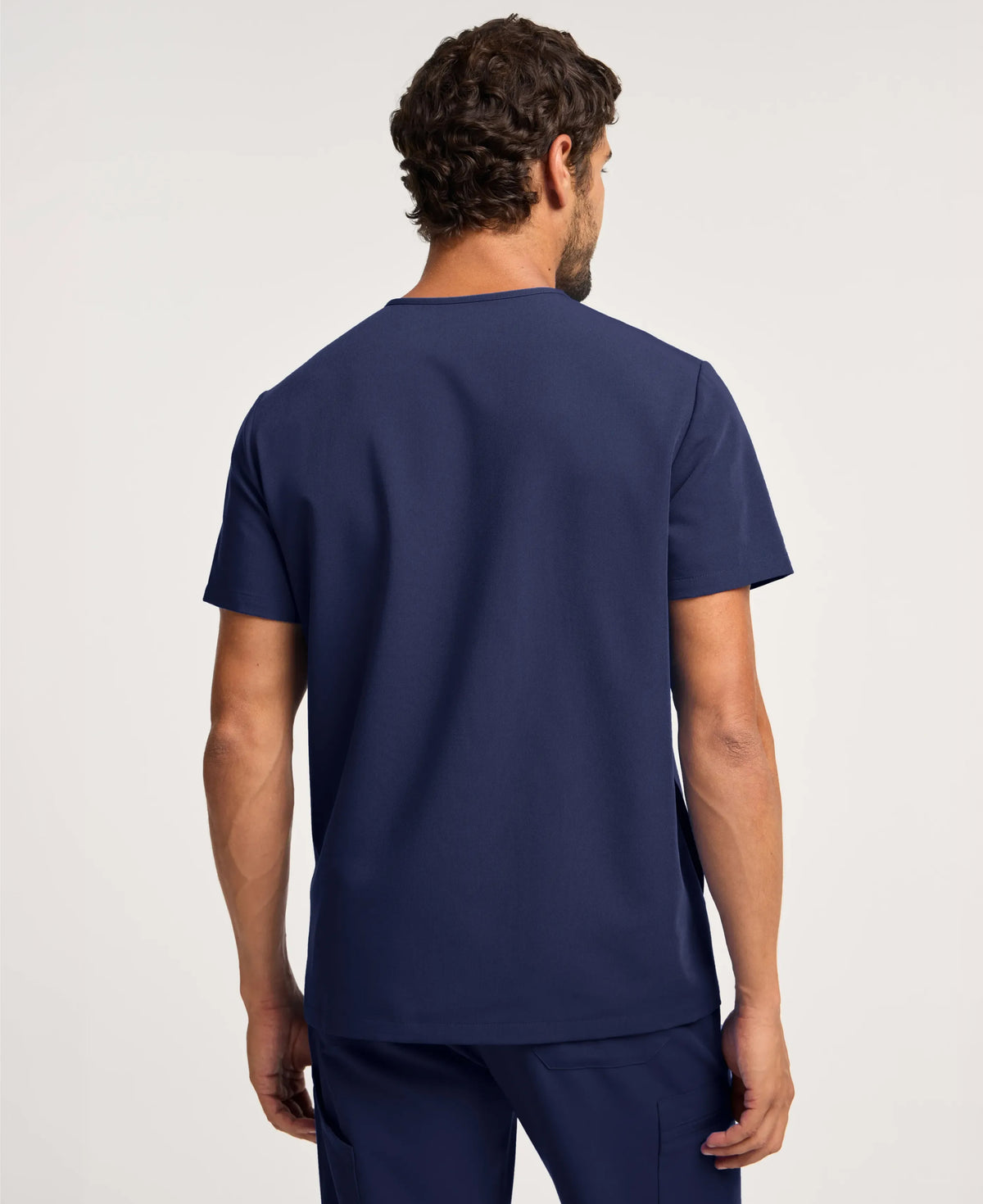 Jaanuu Platt 3-Pocket Scrub Top in Midnight Navy, product photo 5 of 6