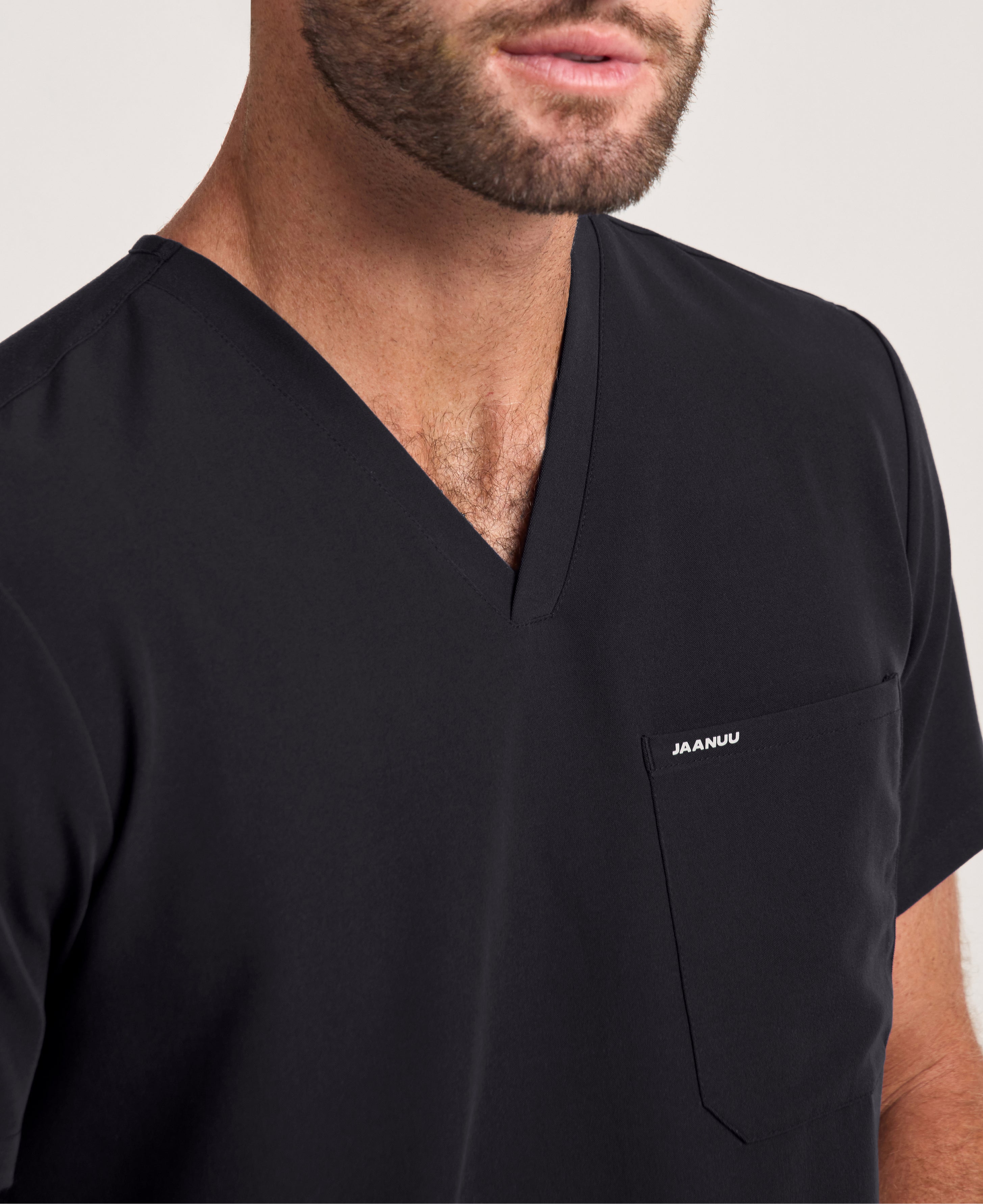Jaanuu Holmes Slim 1-Pocket Scrub Top in Black, product photo 5 of 6