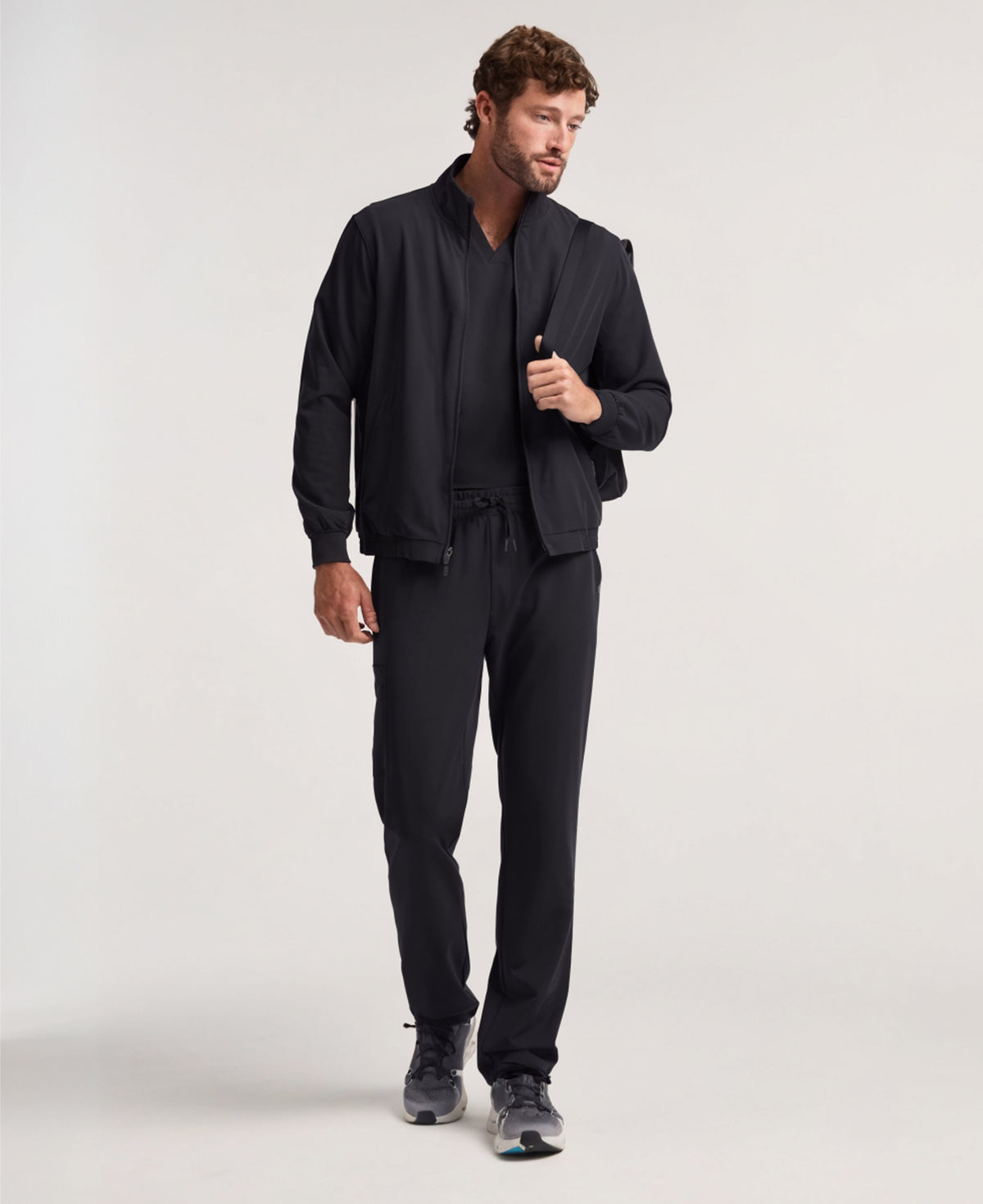 Jaanuu Wolfe 6-Pocket Scrub Jacket in Black, product photo 1 of 6