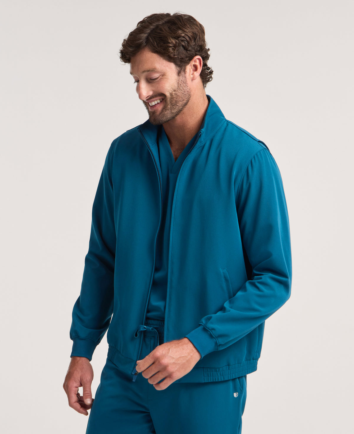 Jaanuu Wolfe 6-Pocket Scrub Jacket in Caribbean Blue, product photo 1 of 6