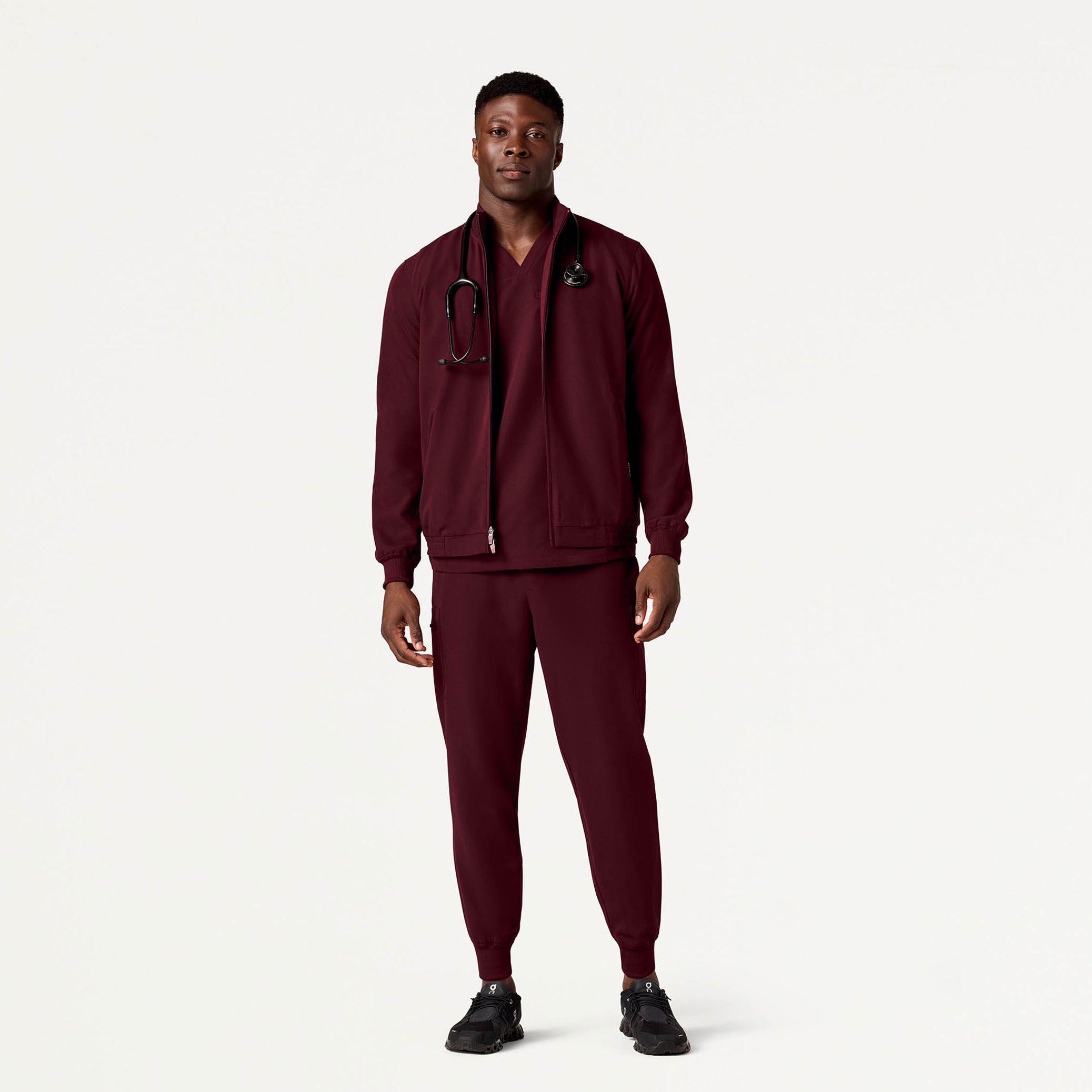 Man wearing Burgundy scrub set with scrub jacket