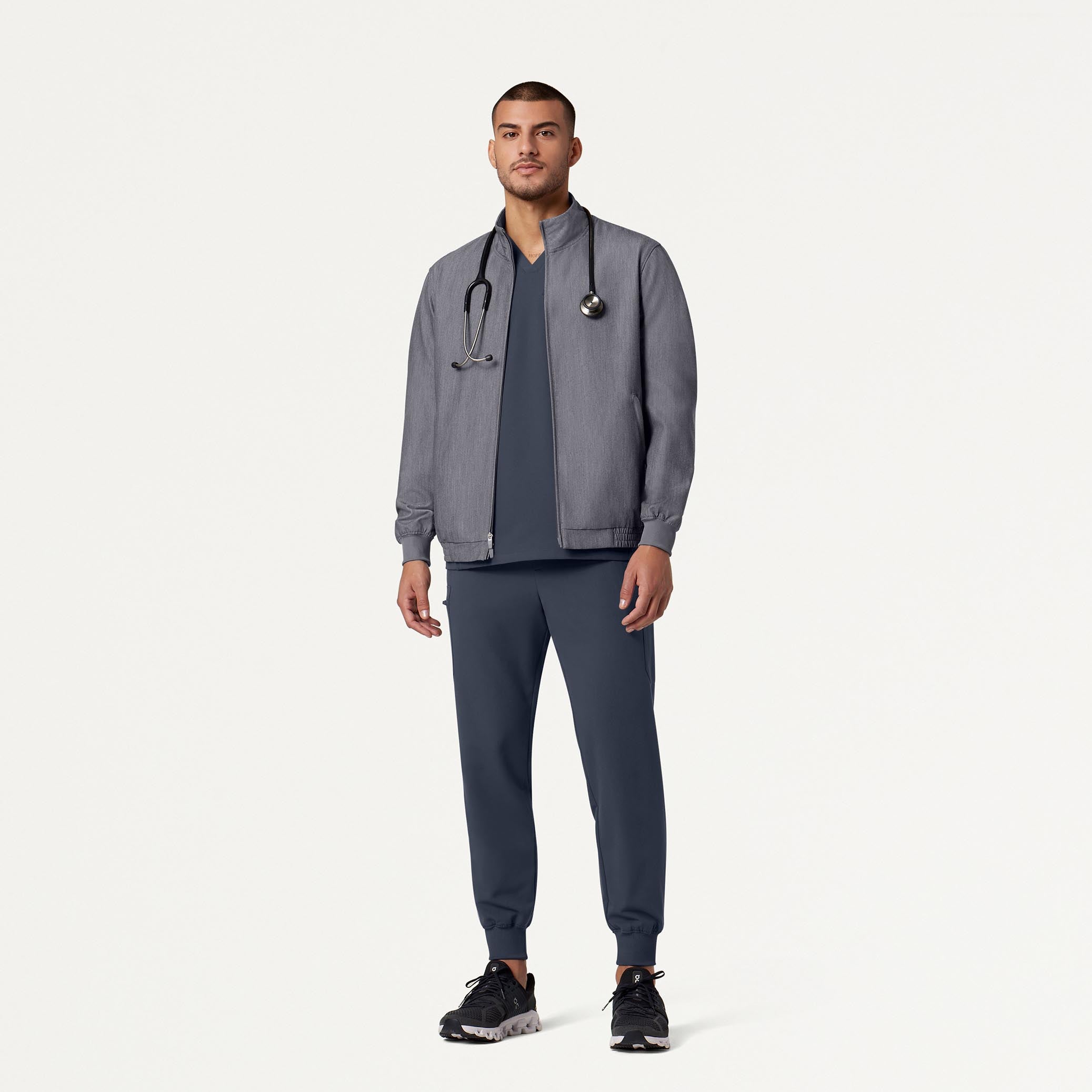 Man wearing Carbon Gray scrub set with scrub jacket