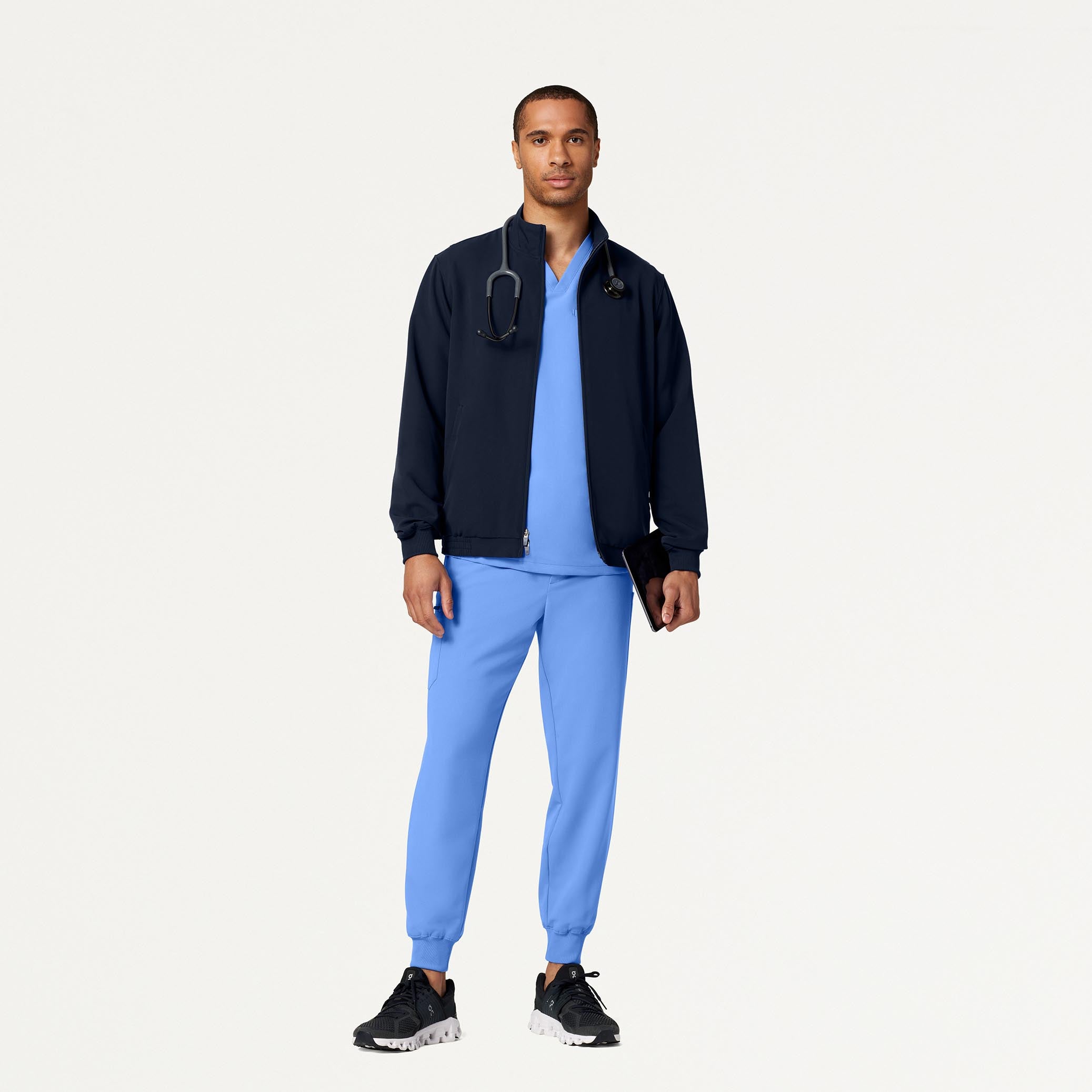 Man wearing Ceil Blue scrub set with scrub jacket
