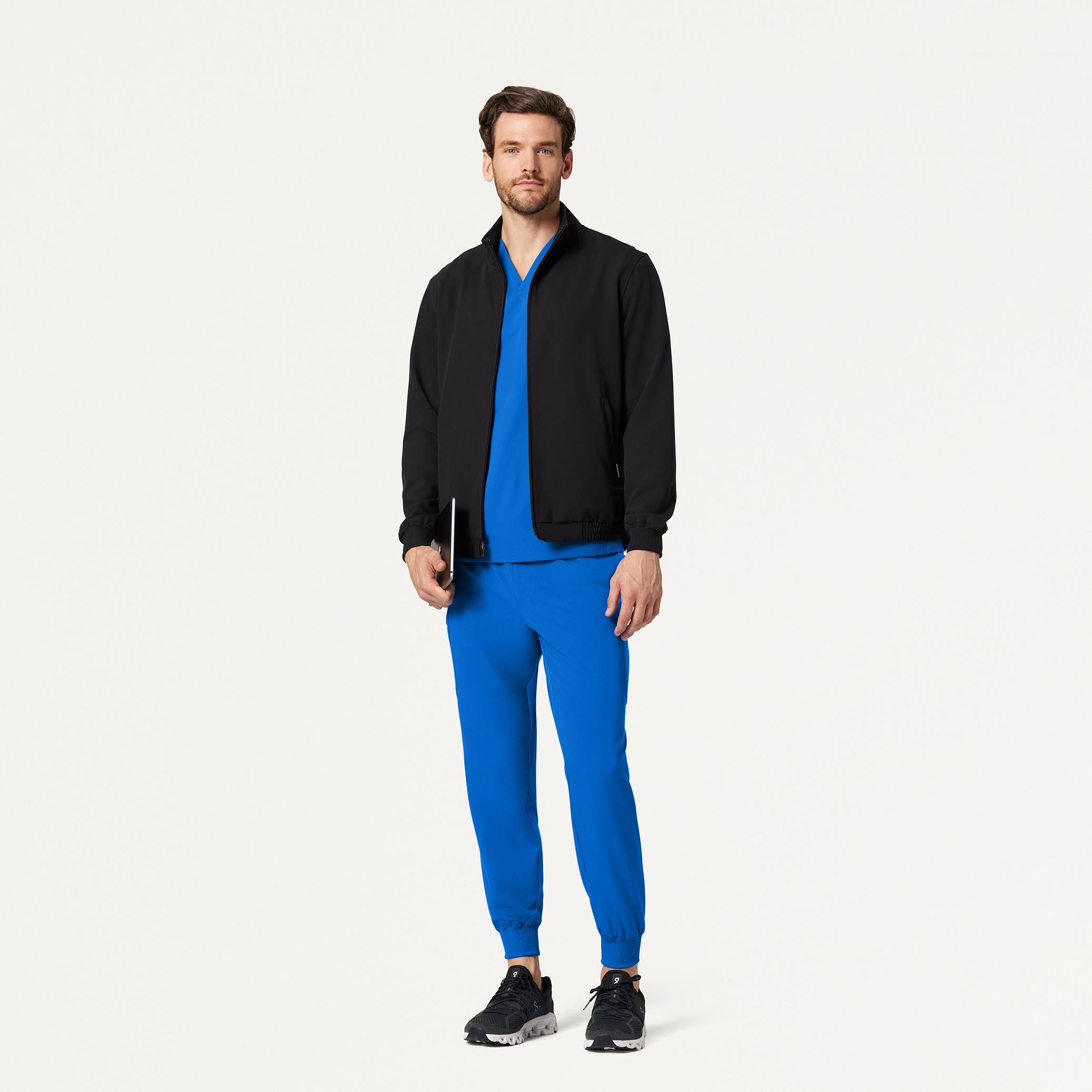 Man wearing Royal Blue scrub set with black scrub jacket