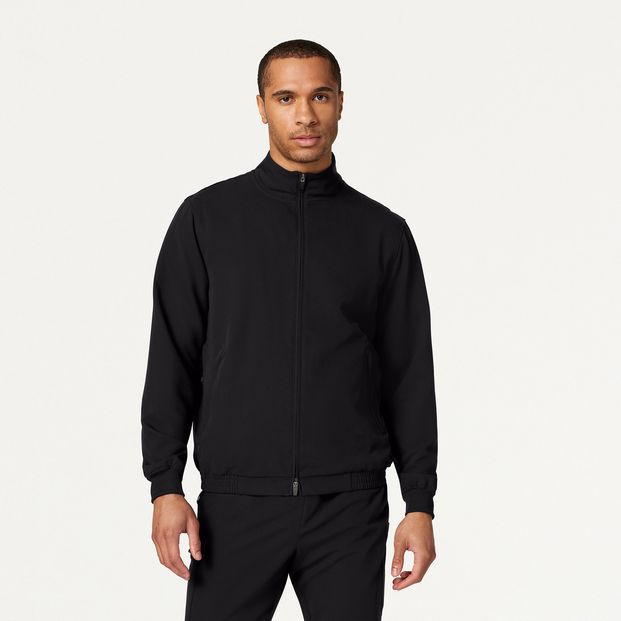 Man wearing black scrub jacket