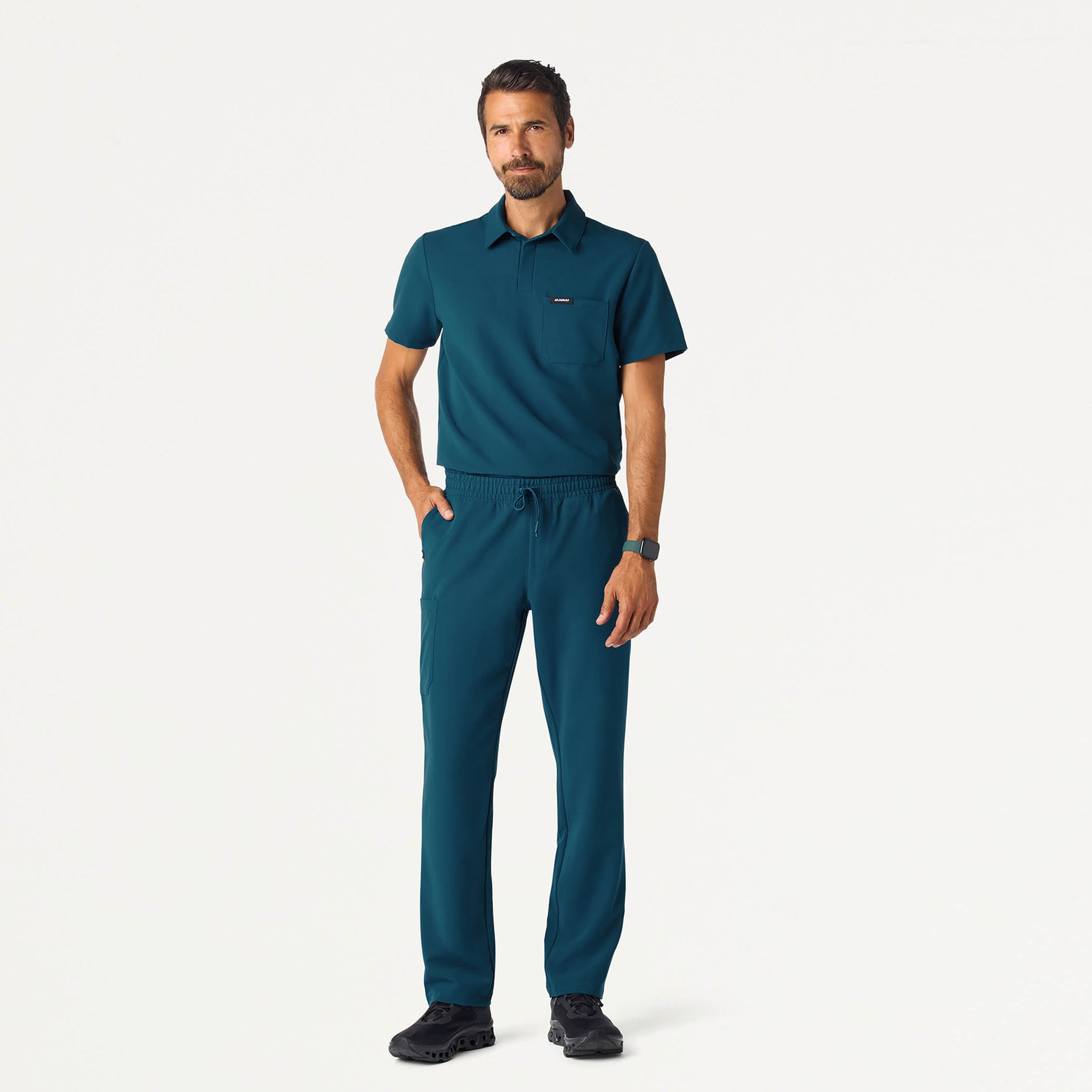 Man wearing a Caribbean Blue scrub top and scrub pant