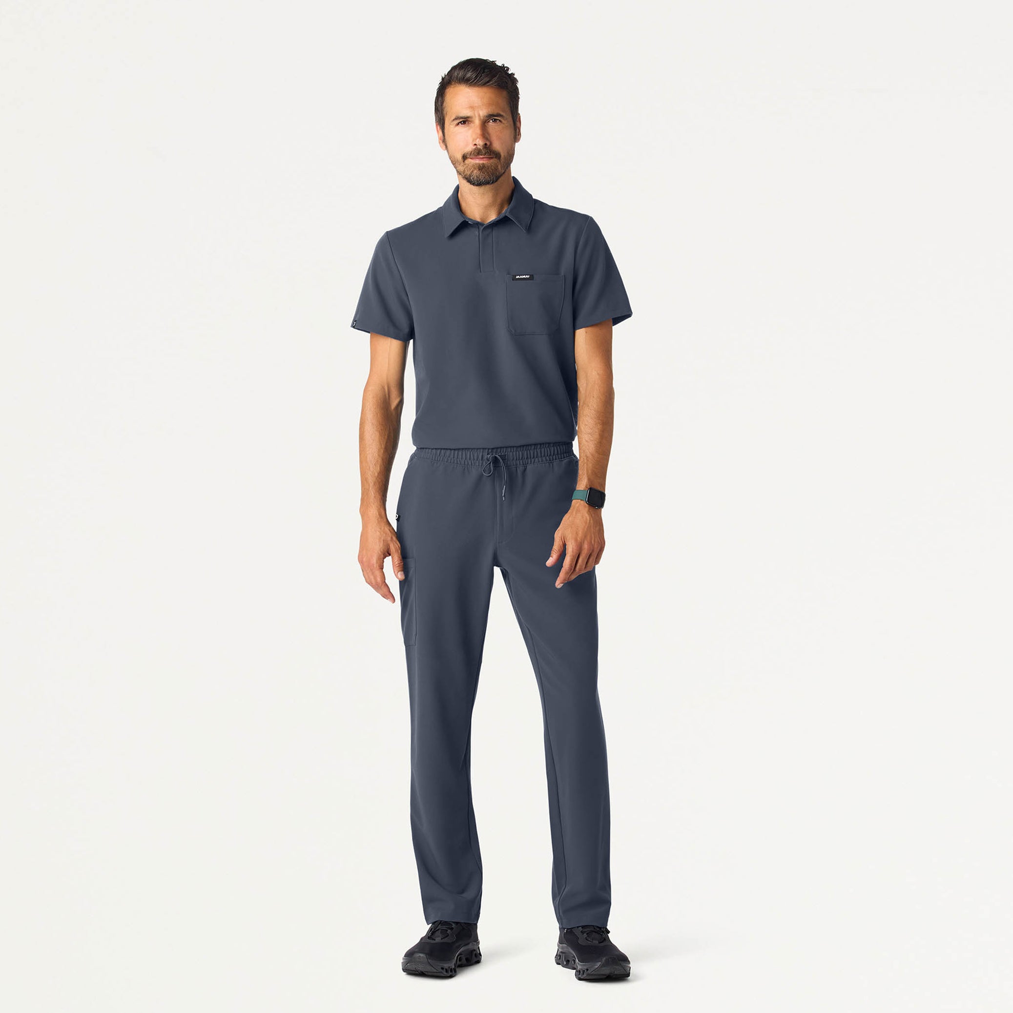 Man wearing a Carbon Gray scrub top and scrub pant