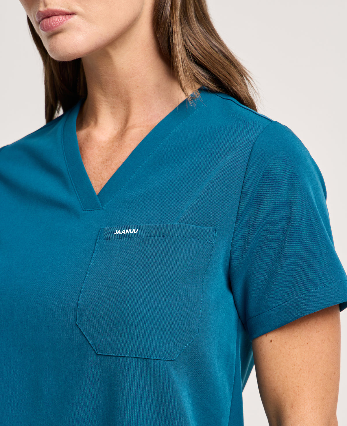 Jaanuu Rhena 1-Pocket Scrub Top in Caribbean Blue, product photo 1 of 6