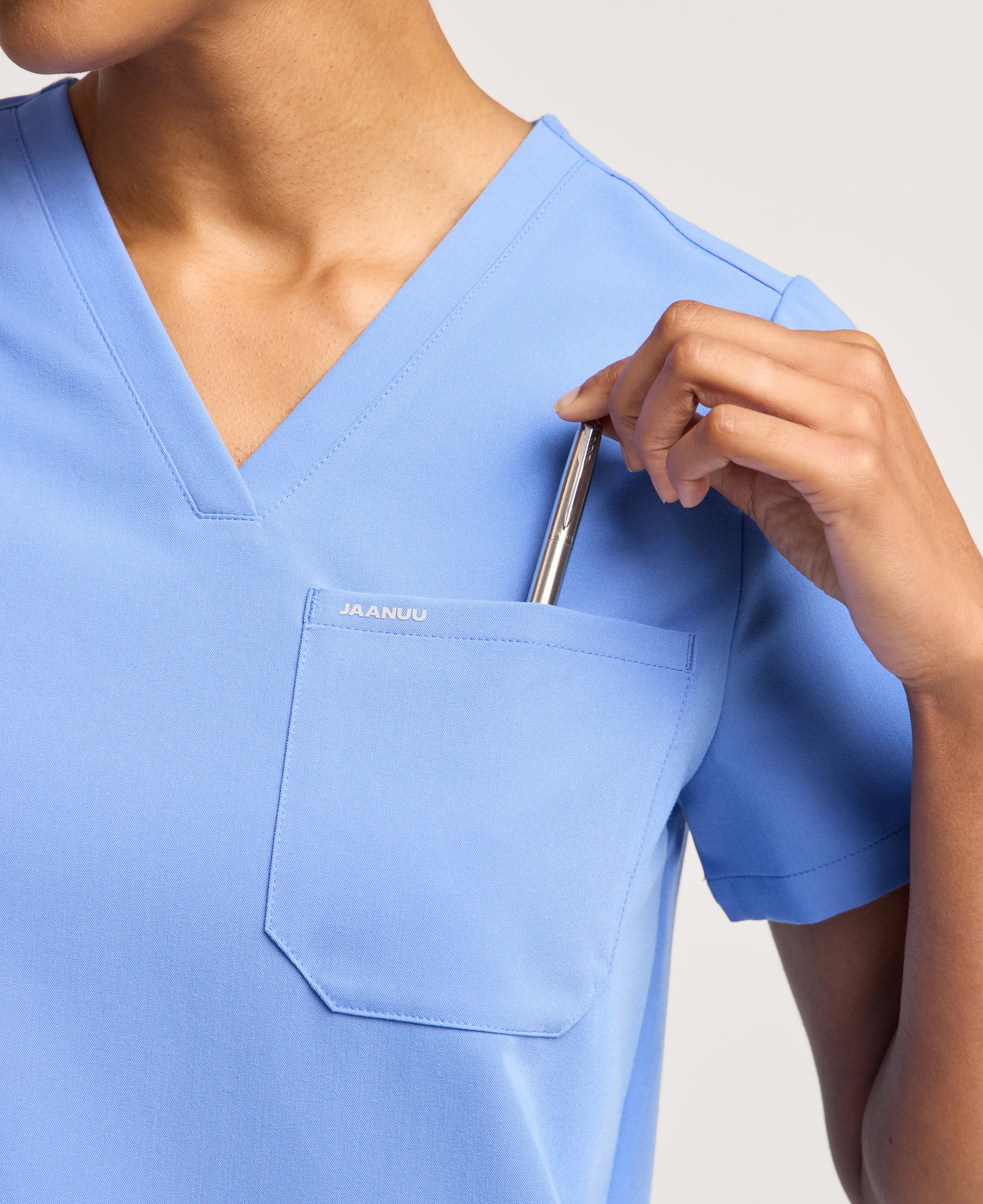 Jaanuu Rhena 1-Pocket Scrub Top in Ceil Blue, product photo 3 of 6