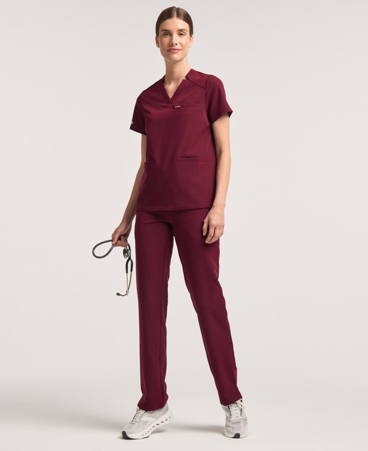 Jaanuu Helia Notched V-Neck Scrub Top in Burgundy, product photo 2 of 6