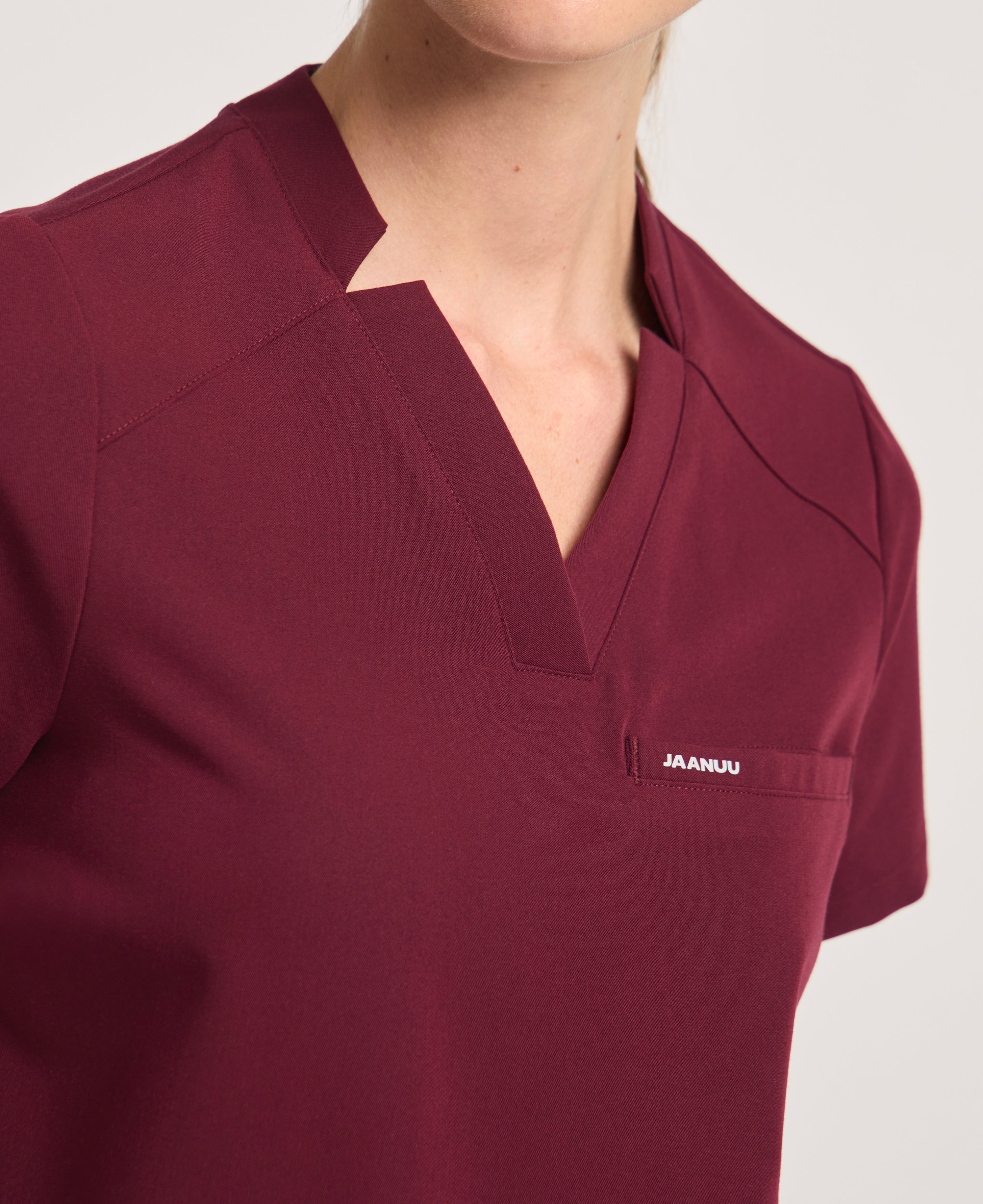 Jaanuu Helia Notched V-Neck Scrub Top in Burgundy, product photo 4 of 6
