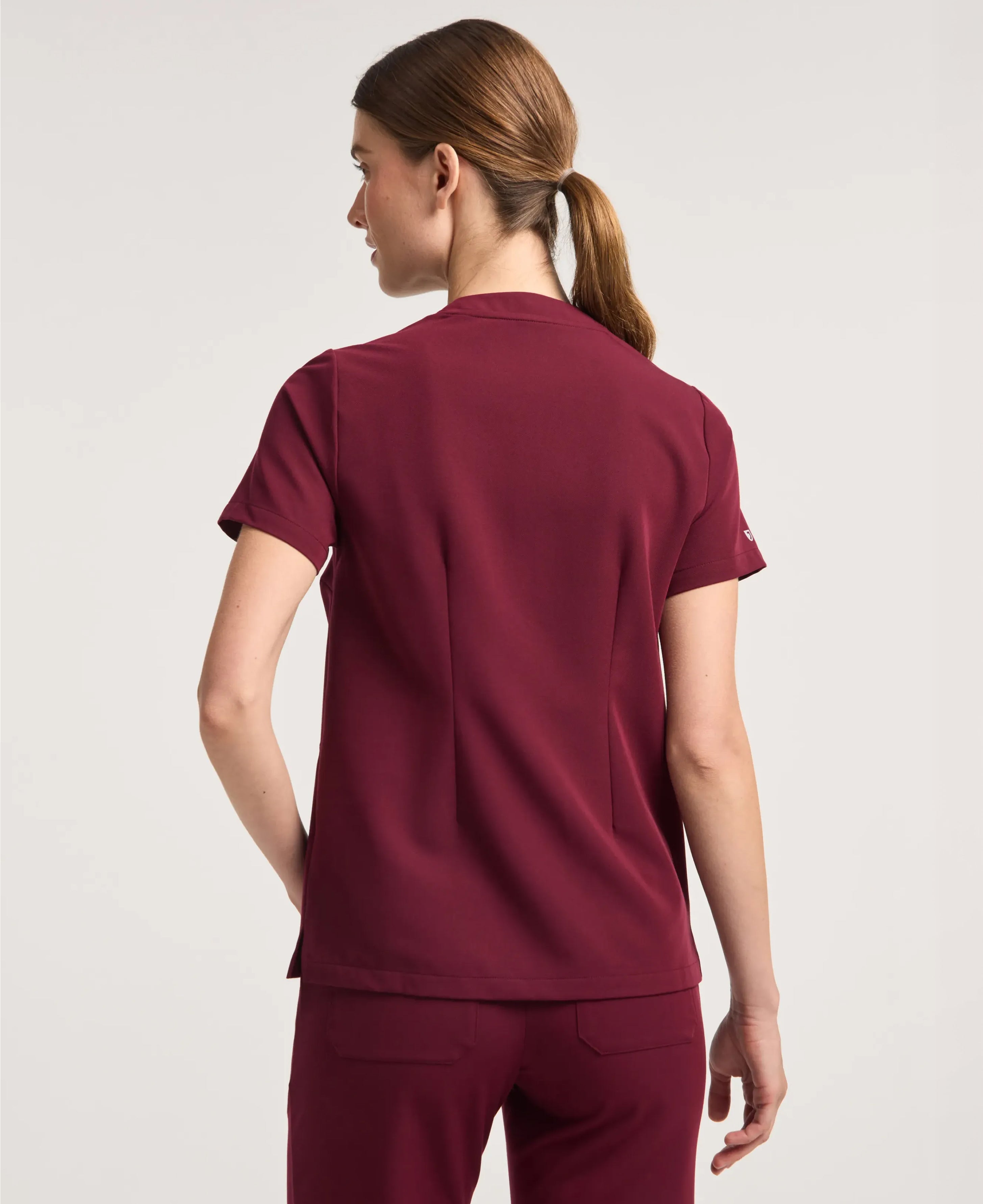 Jaanuu Helia Notched V-Neck Scrub Top in Burgundy, product photo 6 of 6