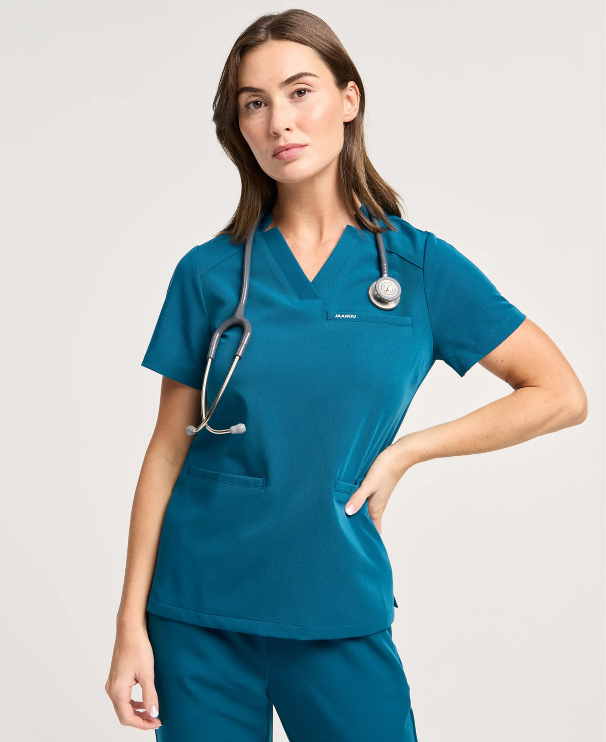 Jaanuu Helia Notched V-Neck Scrub Top in Caribbean Blue, product photo 1 of 6