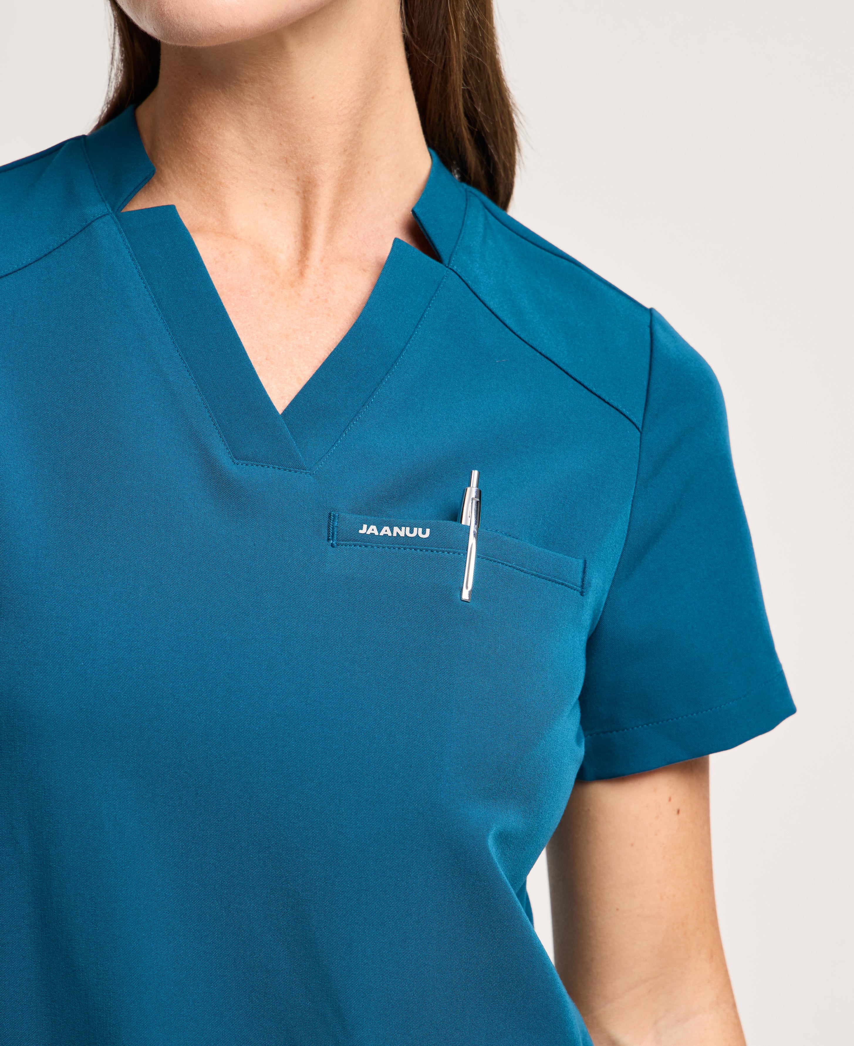 Jaanuu Helia Notched V-Neck Scrub Top in Caribbean Blue, product photo 2 of 6