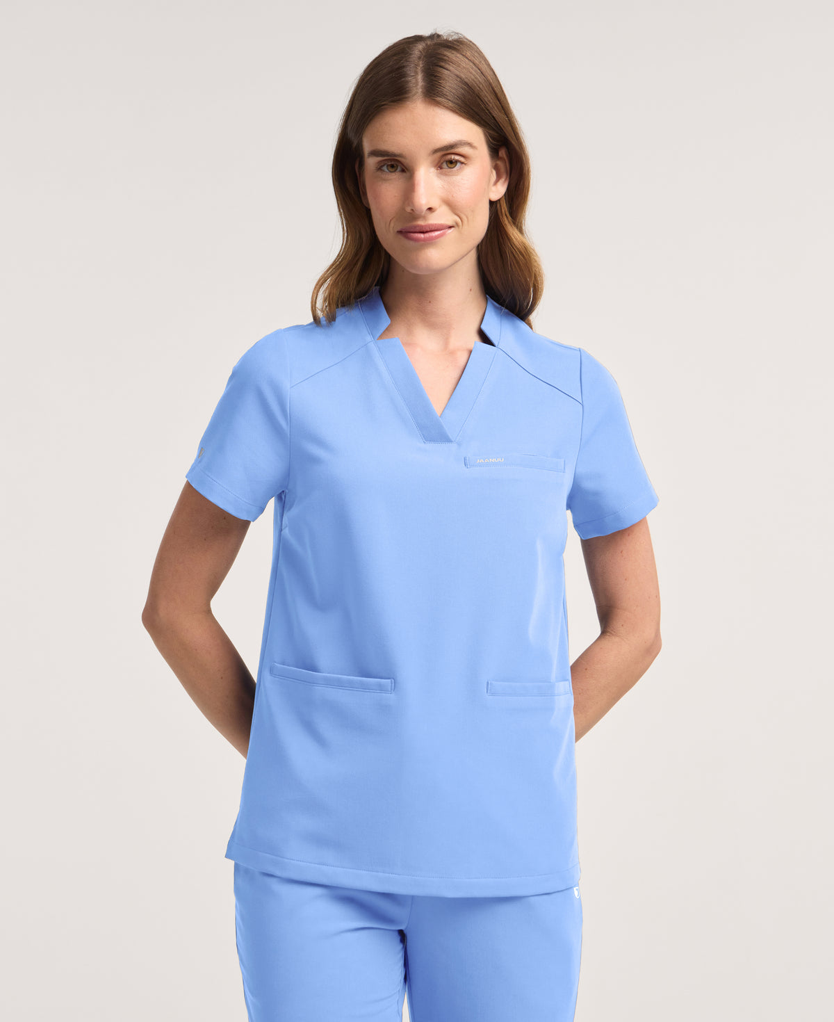 Jaanuu Helia Notched V-Neck Scrub Top in Ceil Blue, product photo 1 of 6