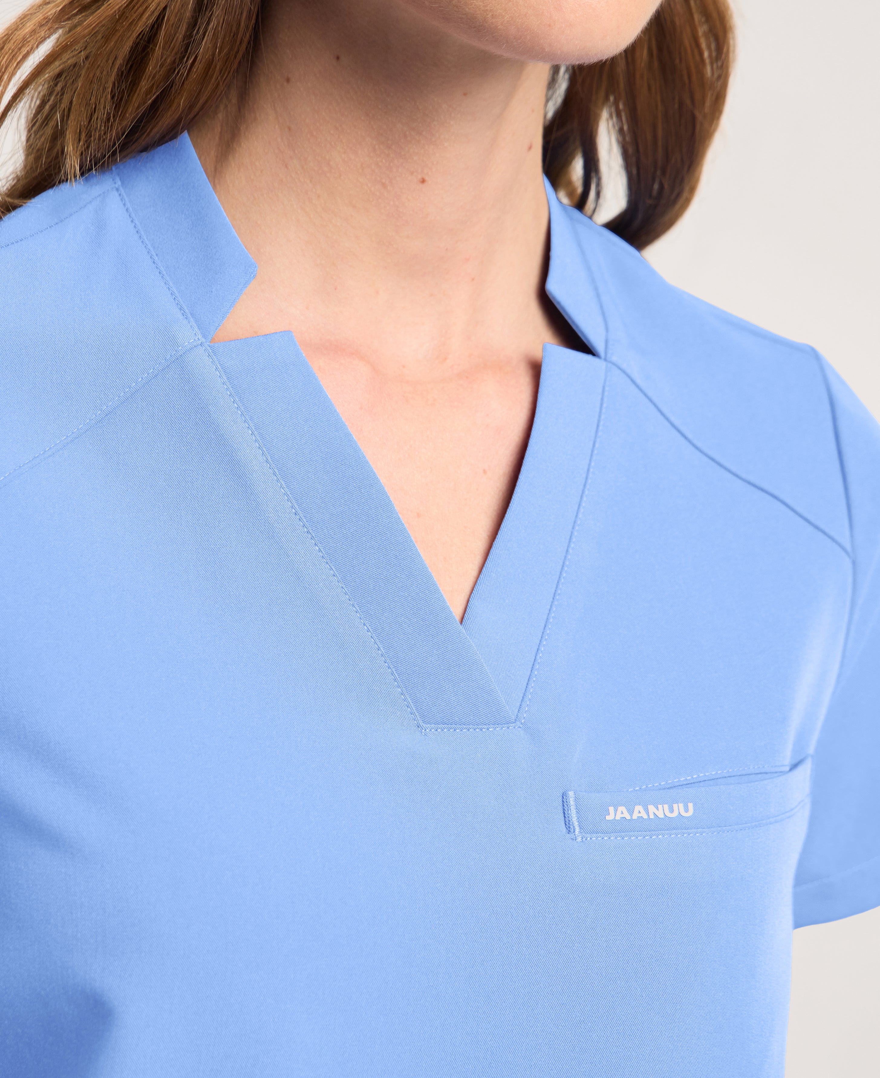 Jaanuu Helia Notched V-Neck Scrub Top in Ceil Blue, product photo 3 of 6