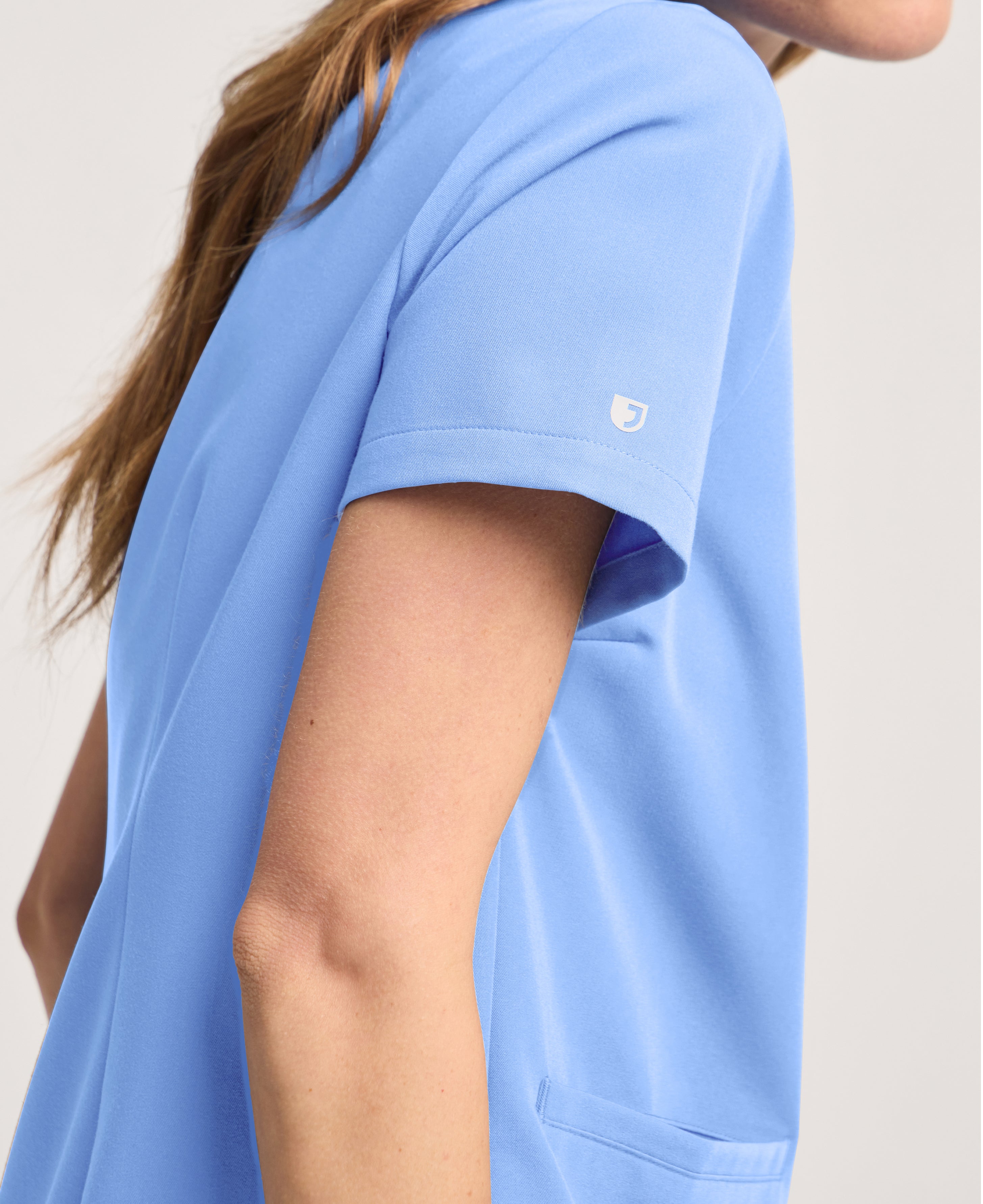 Jaanuu Helia Notched V-Neck Scrub Top in Ceil Blue, product photo 5 of 6