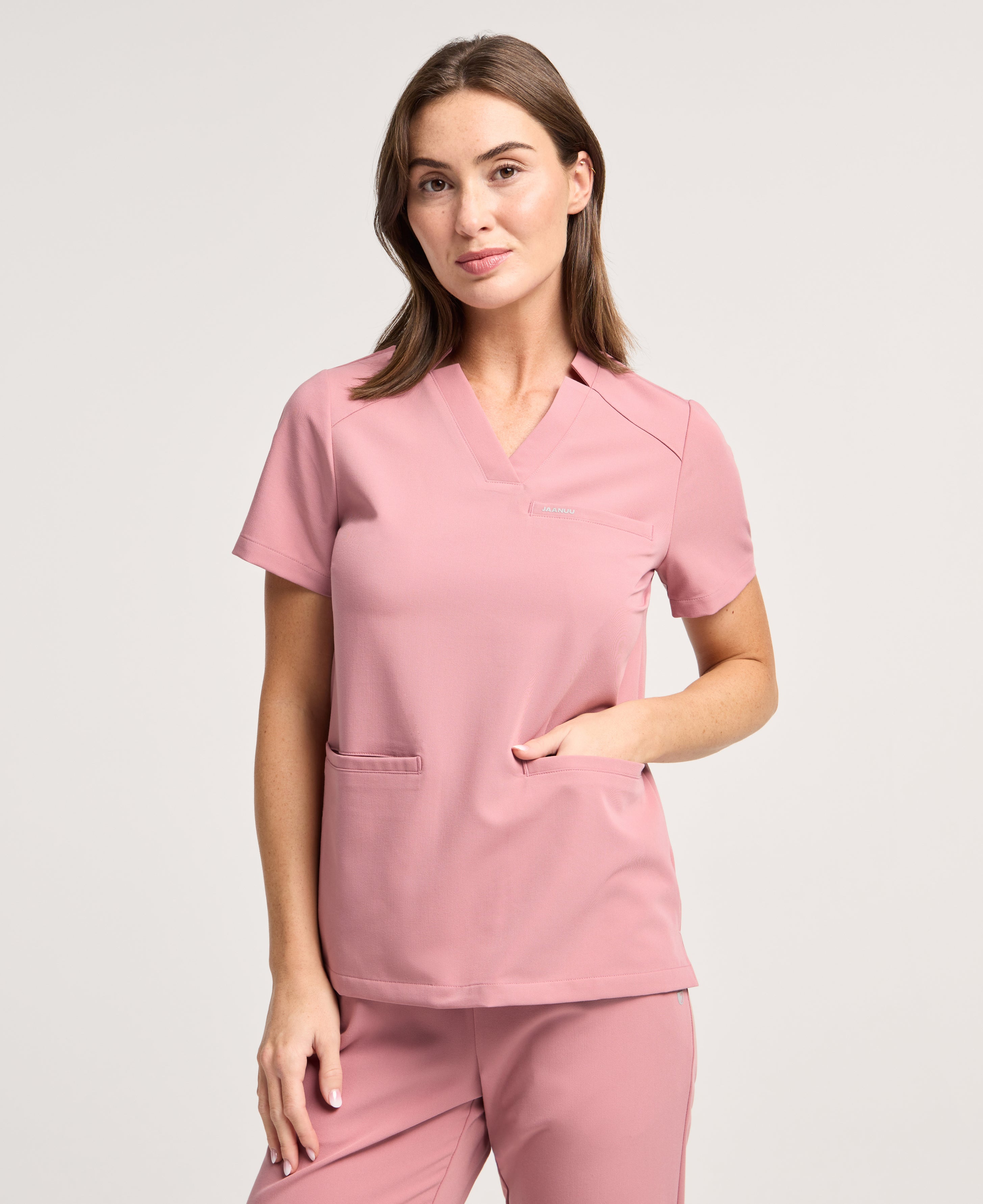 Jaanuu Helia Notched V-Neck Scrub Top in Mauve, product photo 1 of 6