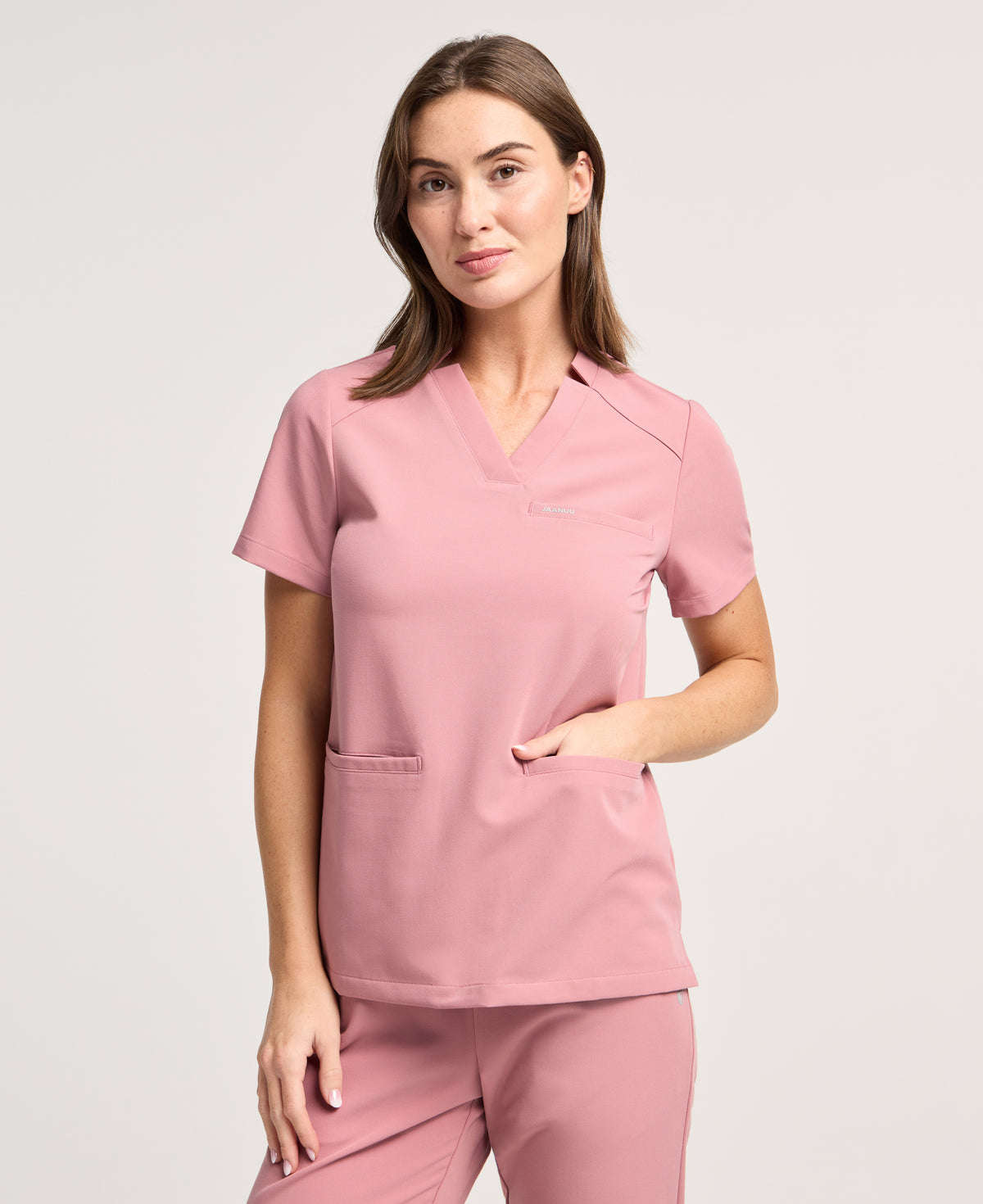 Jaanuu Helia Notched V-Neck Scrub Top in Mauve, product photo 1 of 6