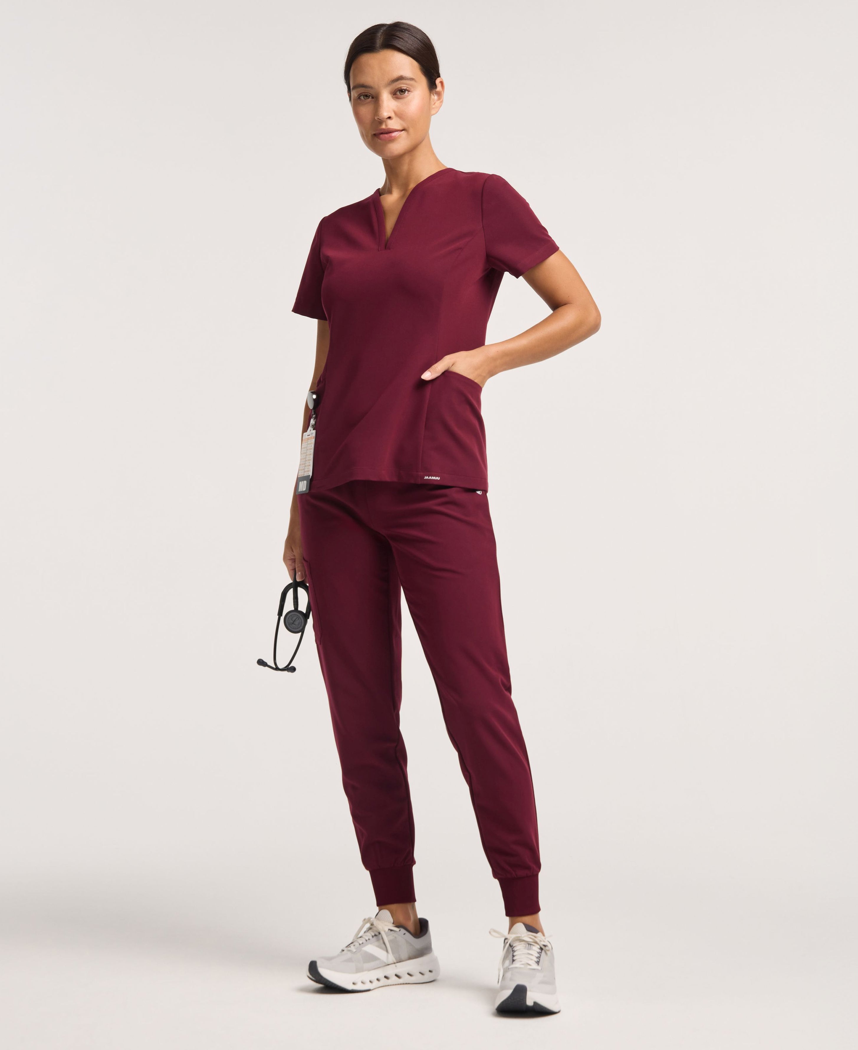 Jaanuu Calix Fit & Flare Scrub Top in Burgundy, product photo 1 of 6