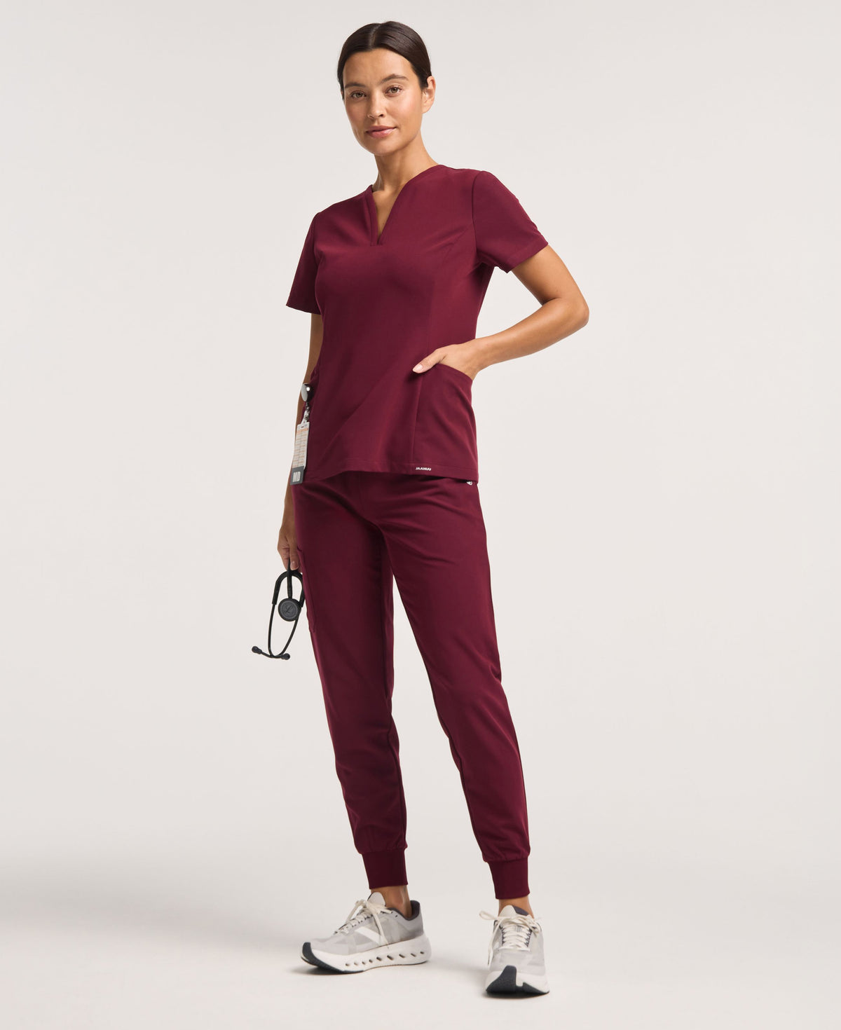 Jaanuu Calix Fit & Flare Scrub Top in Burgundy, product photo 1 of 6