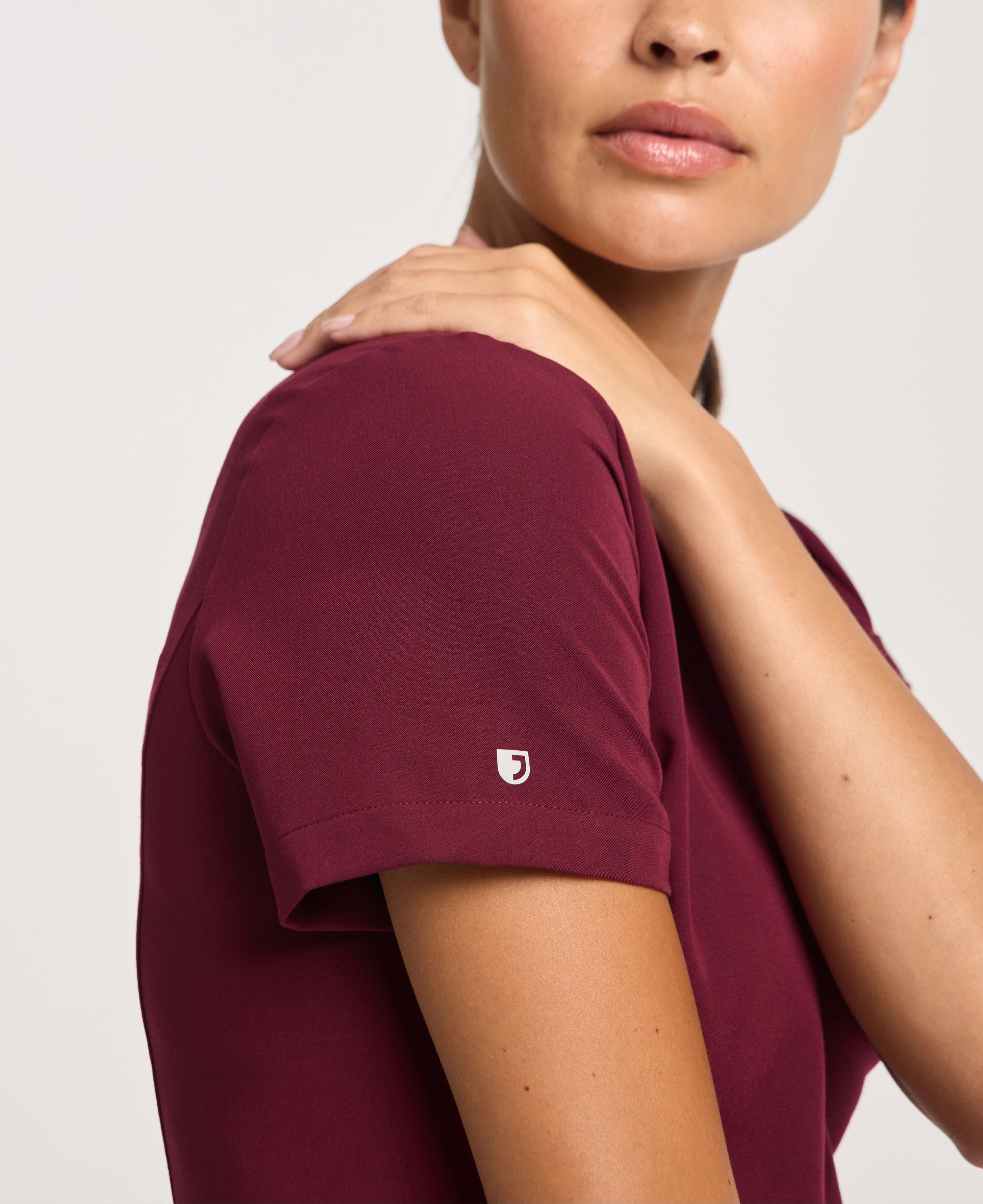 Jaanuu Calix Fit & Flare Scrub Top in Burgundy, product photo 5 of 6