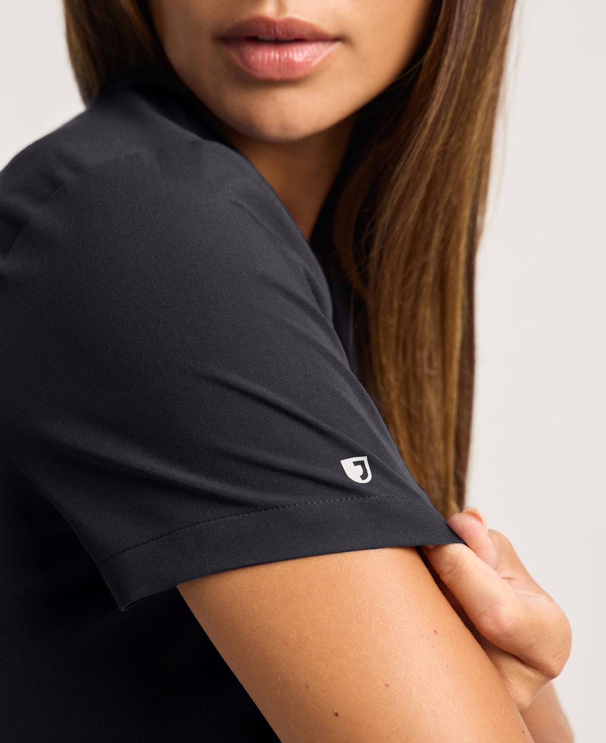 Jaanuu Calix Fit & Flare Scrub Top in Black, product photo 2 of 6