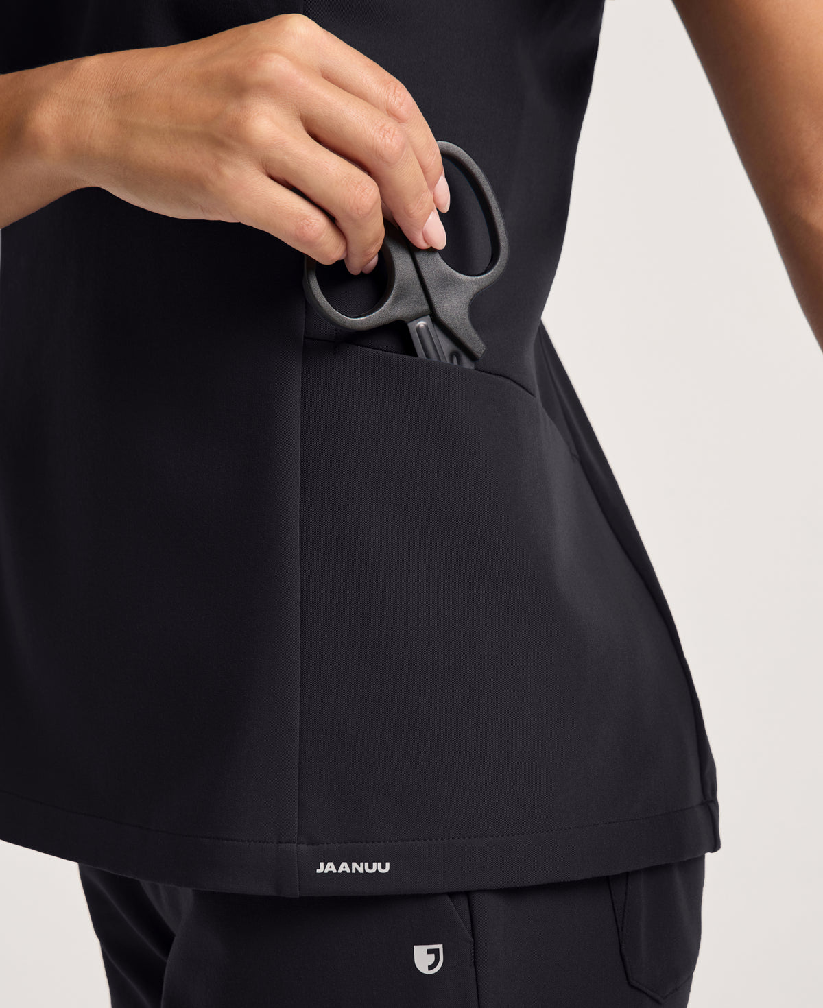 Jaanuu Calix Fit & Flare Scrub Top in Black, product photo 3 of 6