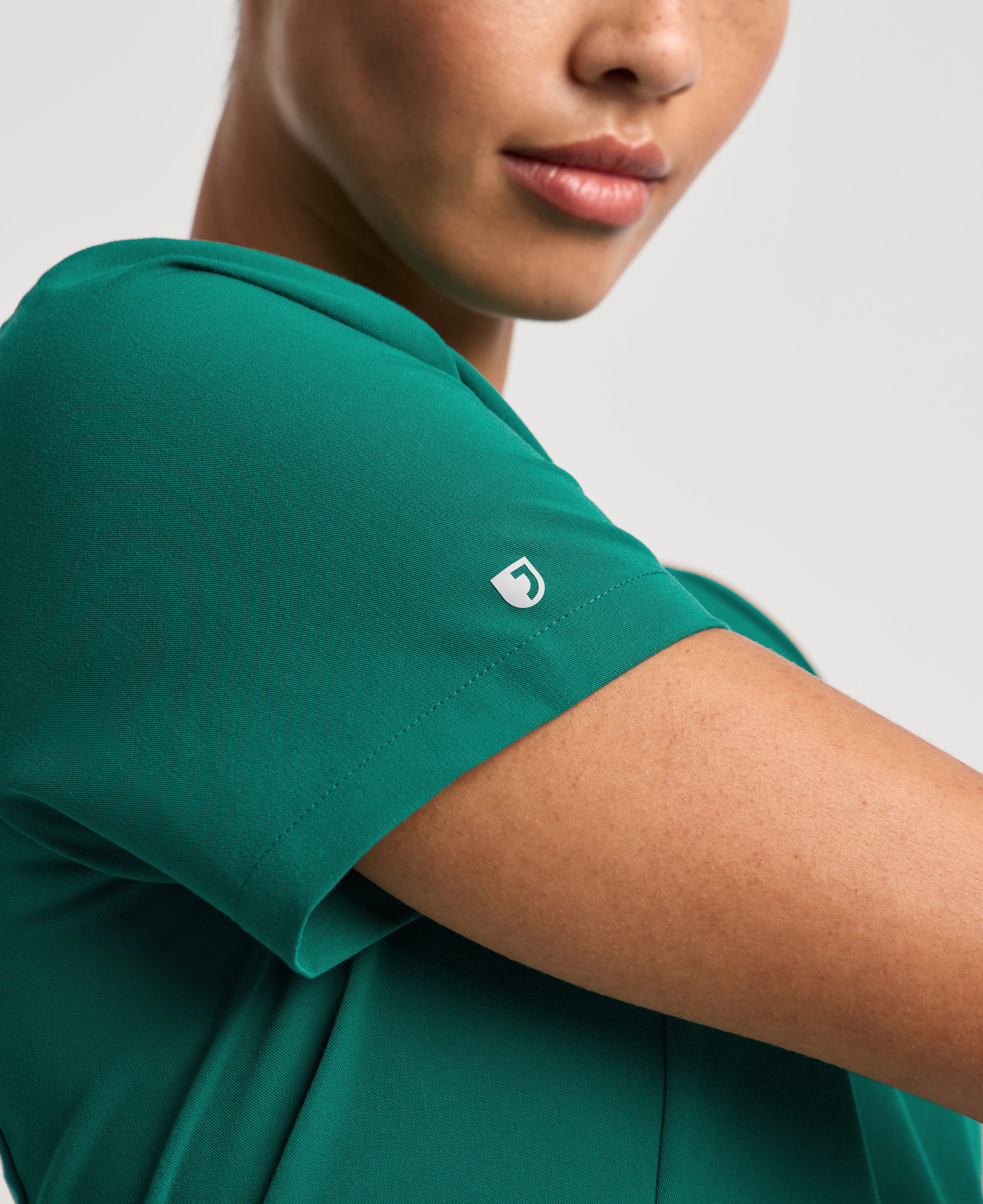 Jaanuu Calix Fit & Flare Scrub Top in Hunter Green, product photo 2 of 6