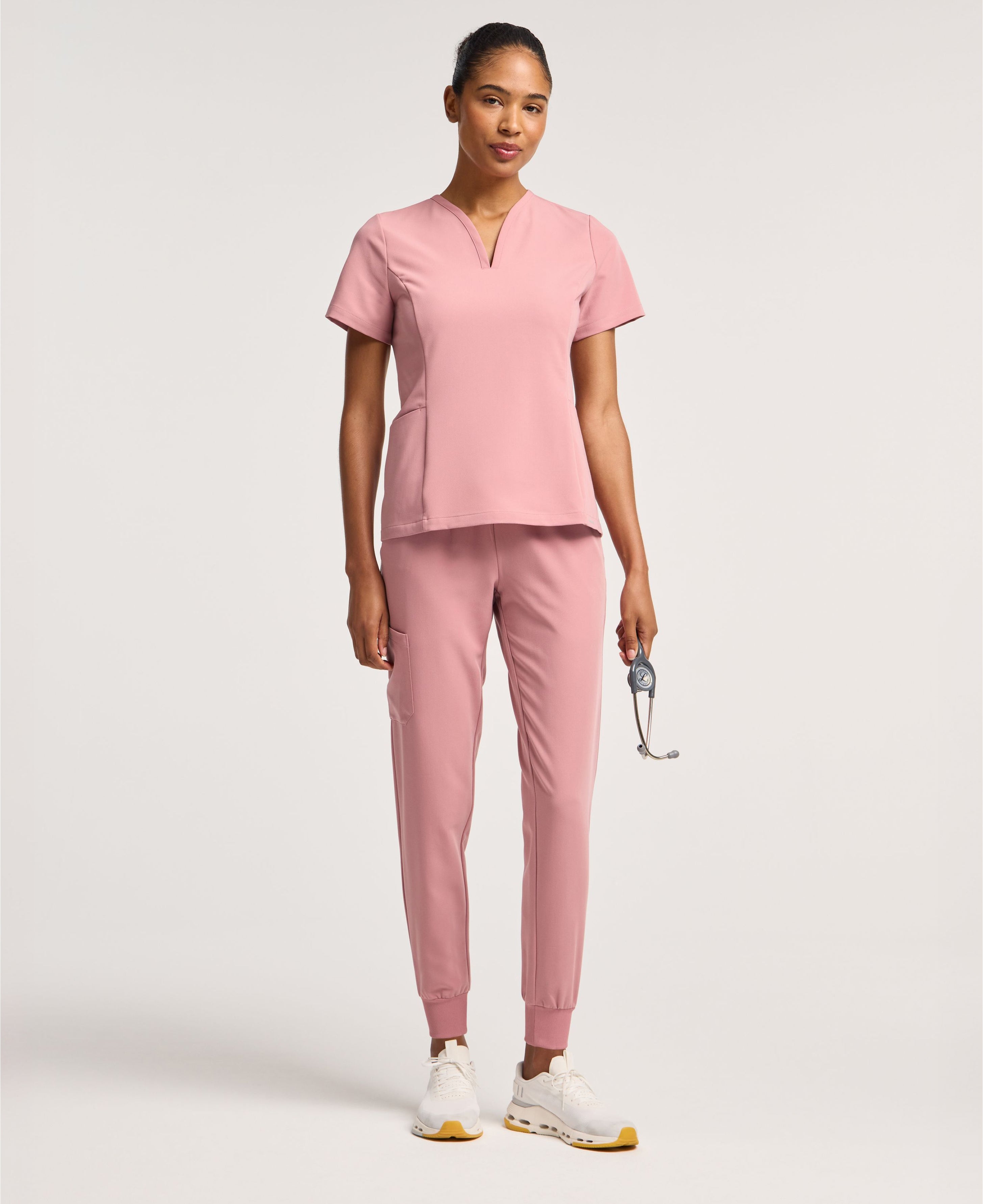 Jaanuu Calix Fit & Flare Scrub Top in Mauve, product photo 1 of 6